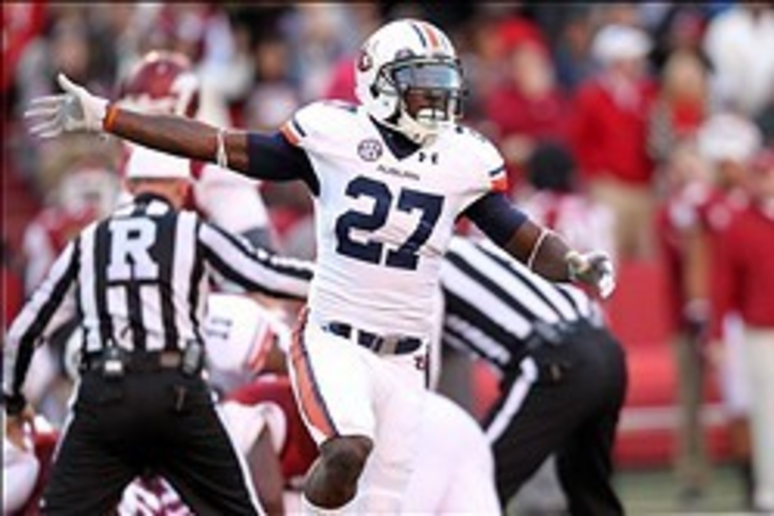 Nov 2, 2013; Fayetteville, AR, USA; Auburn Tigers defensive back Robenson Therezie (27) celebrates after a Tigers fumble recovery in the first quarter against the Arkansas Razorbacks at Donald W. Reynolds Razorback Stadium. Mandatory Credit: Nelson Chenau