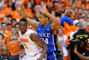 SYRACUSE, NY - FEBRUARY 01:  Jerami Grant #3 of the Syracuse Orange backs into the defense of Andre Dawkins #34 of the Duke Blue Devils during the second half at the Carrier Dome on February 1, 2014 in Syracuse, New York.  Syracuse defeated Duke 91-89 in 