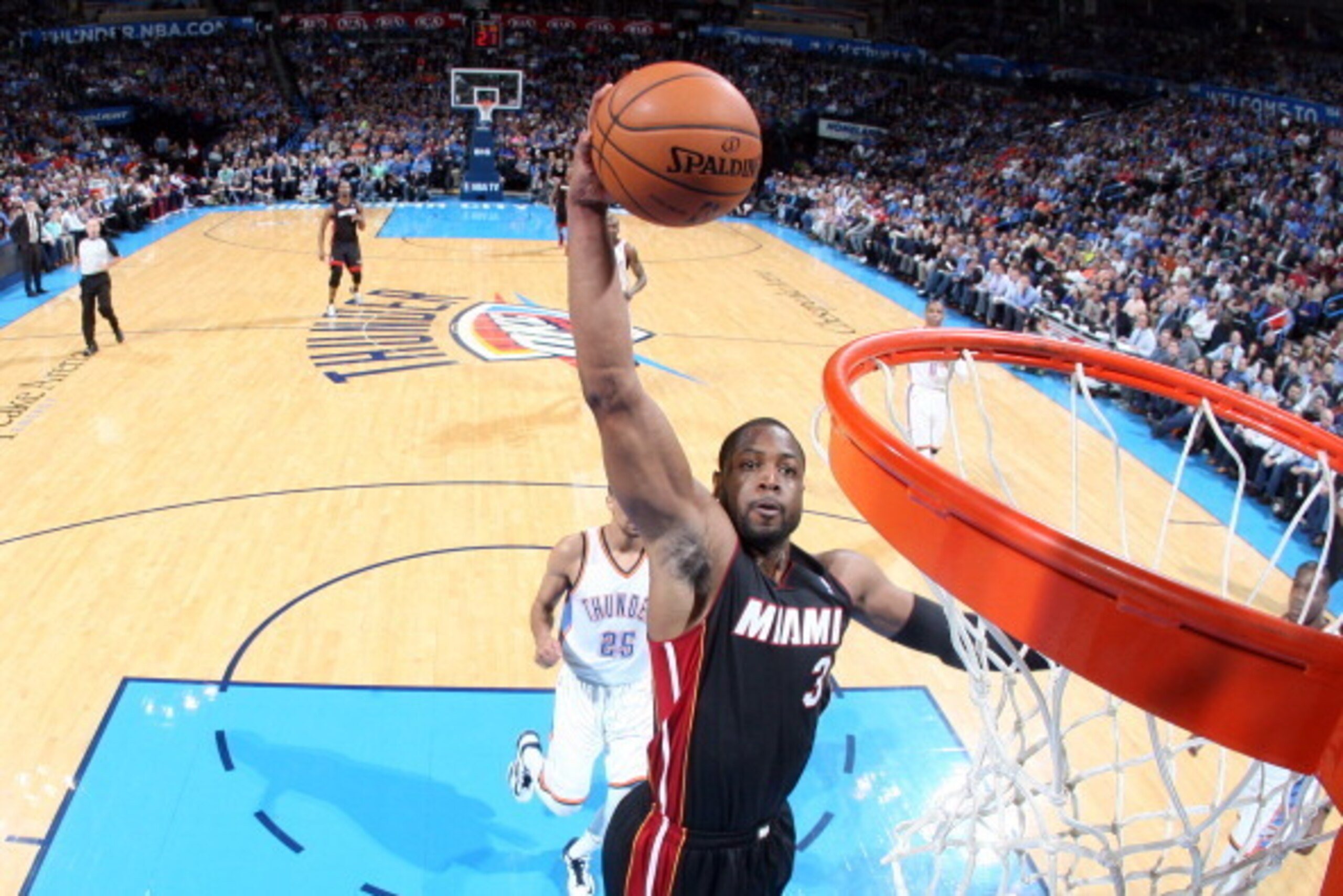 OKLAHOMA CITY, OK - FEBRUARY 20: Dwyane Wade #3 of the Miami Heat dunks against the Oklahoma City Thunder on February 20, 2014 at the Chesapeake Energy Arena in Oklahoma City, Oklahoma. NOTE TO USER: User expressly acknowledges and agrees that, by downloa