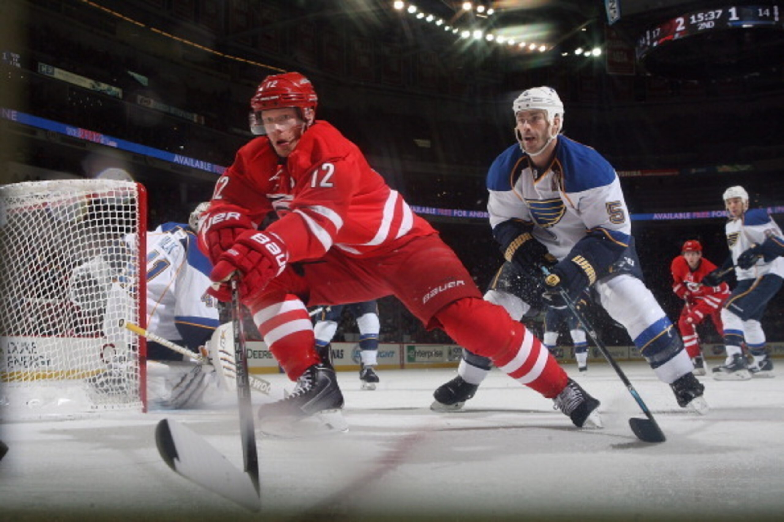 RALEIGH, NC - JANUARY 31: Eric Staal #12 of the Carolina Hurricanes skates into the corner to collect the puck as he is pressured by Barret Jackman #5 of the St. Louis Blues during their NHL game at PNC Arena on January 31, 2014 in Raleigh, North Carolina