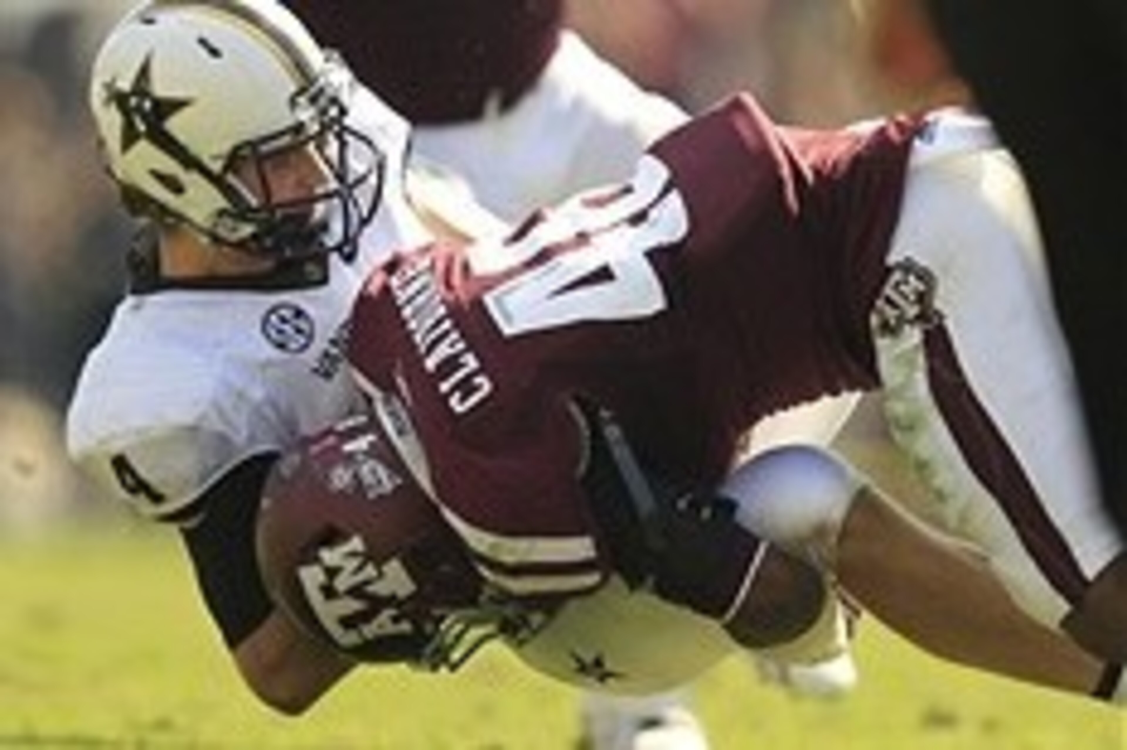 Oct 26, 2013; College Station, TX, USA; Texas A&M Aggies linebacker Darian Claiborne (48) sacks Vanderbilt Commodores quarterback Patton Robinette (4) during the first half at Kyle Field. Mandatory Credit: Thomas Campbell-USA TODAY Sports