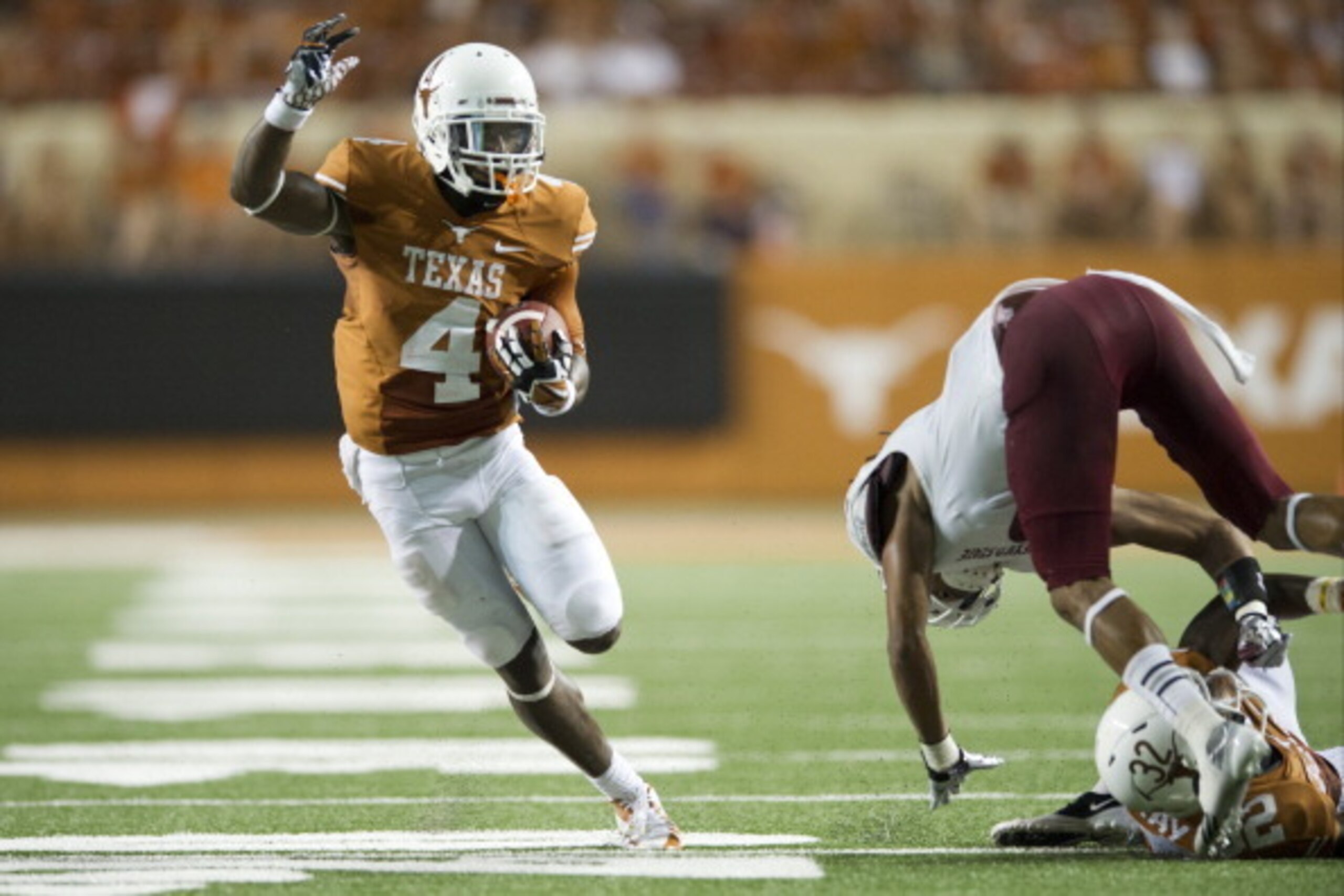 AUSTIN, TX - AUGUST 31: Daje Johnson #4 of the Texas Longhorns breaks free for a 24 yard touchdown run against the New Mexico State Aggies on August 31, 2013 at Darrell K Royal-Texas Memorial Stadium in Austin, Texas. (Photo by Cooper Neill/Getty Images)