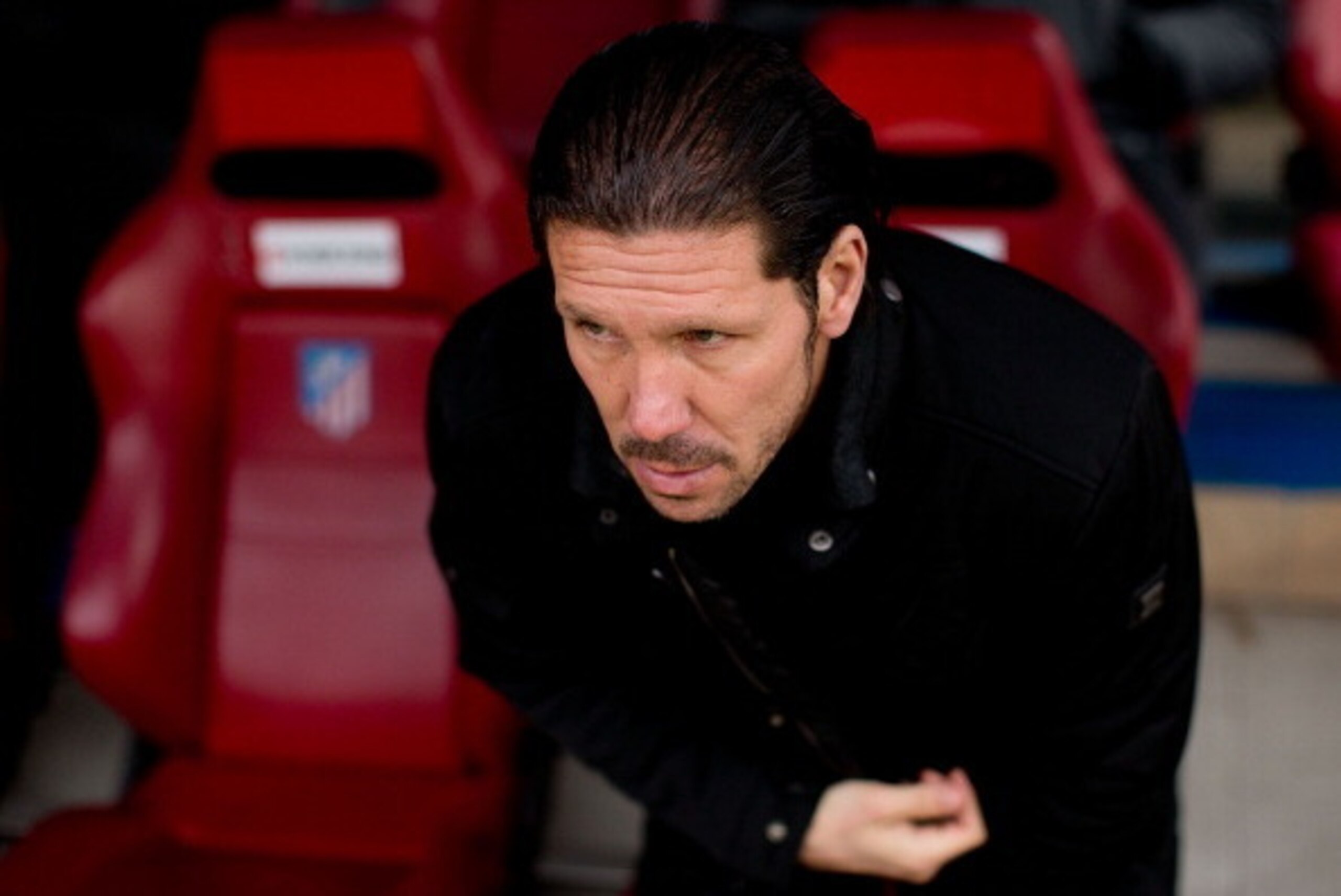 MADRID, SPAIN - FEBRUARY 15: Head coach Diego Pablo Simeone of Atletico de Madrid sits on the bench prior to start the La Liga match between Club Atletico de Madrid and Real Valladolid CF  at Vicente Calderon Stadium on February 15, 2014 in Madrid, Spain.