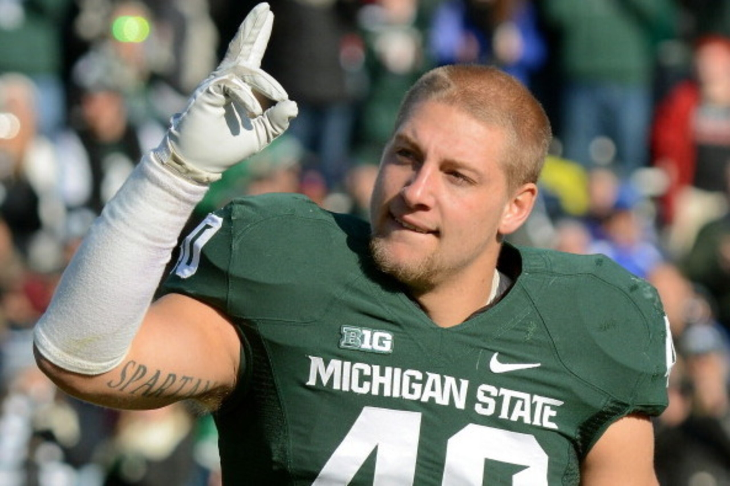 EAST LANSING, MI - NOVEMBER 30:  Max Bullough #40 of the Michigan State Spartans waves to the crowd during player introductions prior to the game against the Minnesota Golden Gophers at Spartan Stadium on November 30, 2013 in East Lansing, Michigan. The S