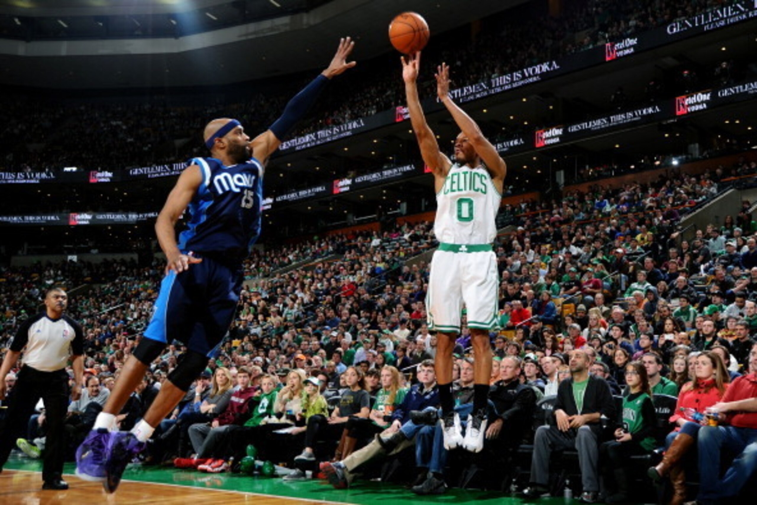 BOSTON, MA - FEBRUARY 9: Avery Bradley #0 of the Boston Celtics shoots the ball against Vince Carter #25 of the Dallas Mavericks on February 9, 2014 at the TD Garden in Boston, Massachusetts.  NOTE TO USER: User expressly acknowledges and agrees that, by 