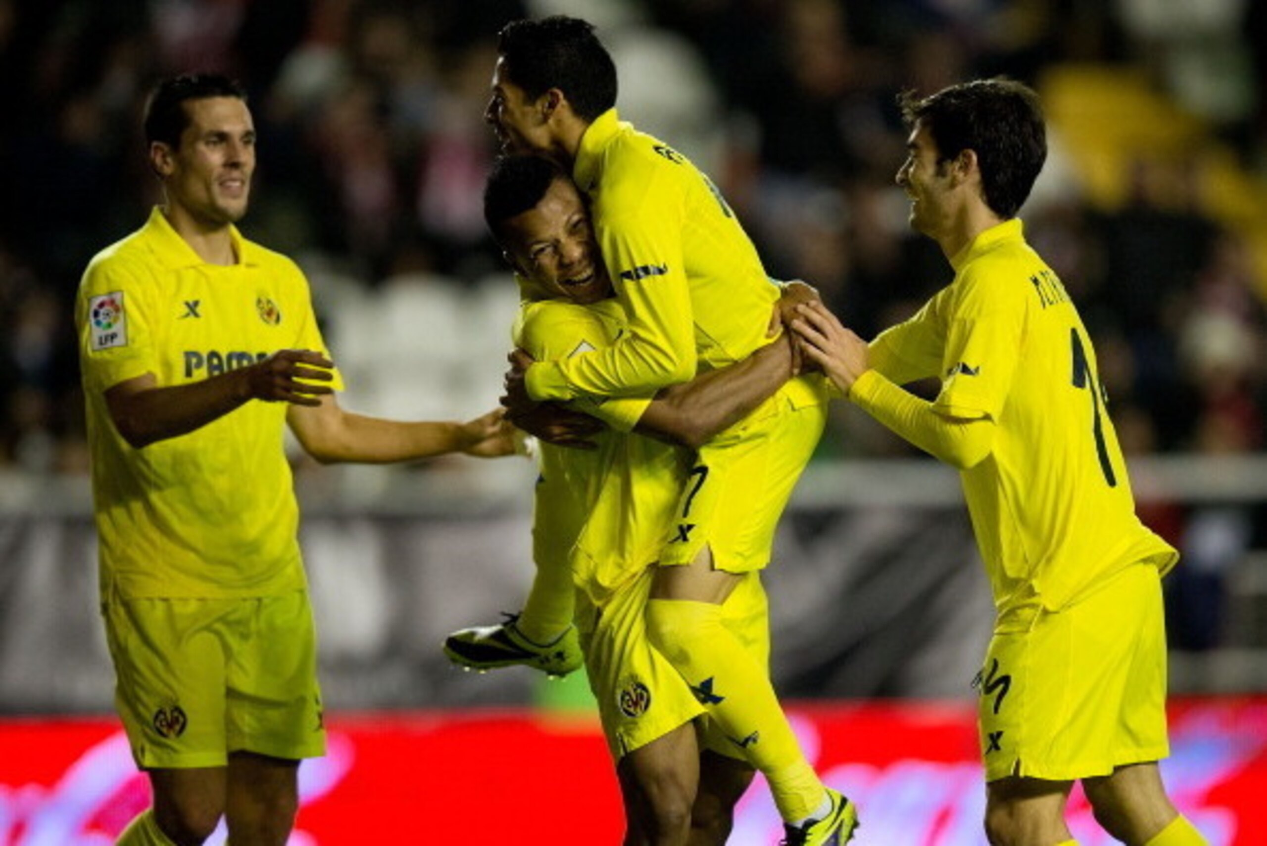 MADRID, SPAIN - JANUARY 06: Ikechukwu Uche (2ndL) of Villarreal CF celebrates scoring their fourth goal with teammates Jeremy Louis Perbet (L), Javier Ignacio Aquino (2ndR) and Manuel Trigueros (R) during the La Liga match between Rayo Vallecano de Madri MADRID, SPAIN - JANUARY 06: Ikechukwu Uche (2ndL) of Villarreal CF celebrates scoring their fourth goal with teammates Jeremy Louis Perbet (L), Javier Ignacio Aquino (2ndR) and Manuel Trigueros (R) during the La Liga match between Rayo Vallecano de Madri