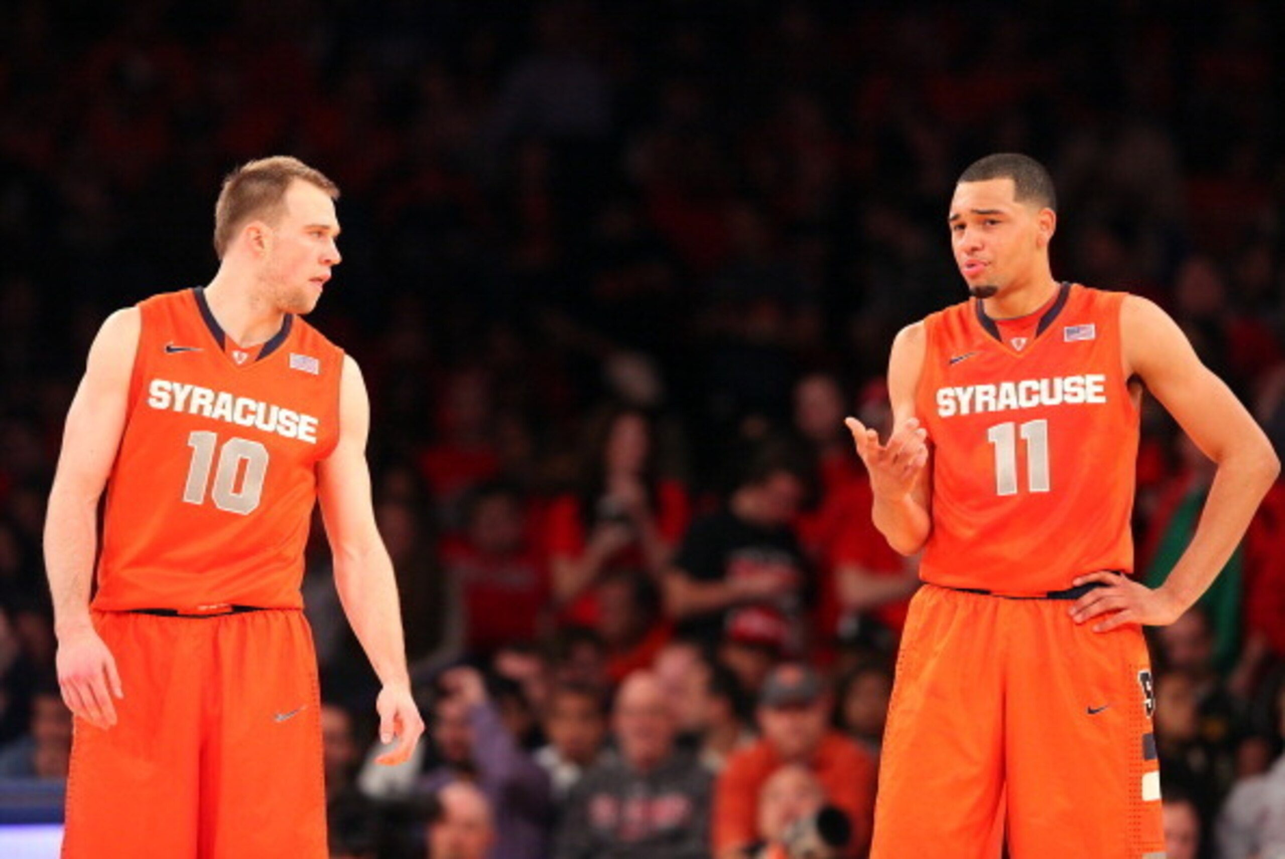 NEW YORK, NY - DECEMBER 15:  Trevor Cooney #10 and Tyler Ennis #11 of the Syracuse Orange talk on the court during the game against the St. John's Red Storm at Madison Square Garden on December 15, 2013 in New York City. (Photo by Nate Shron/Getty Images)