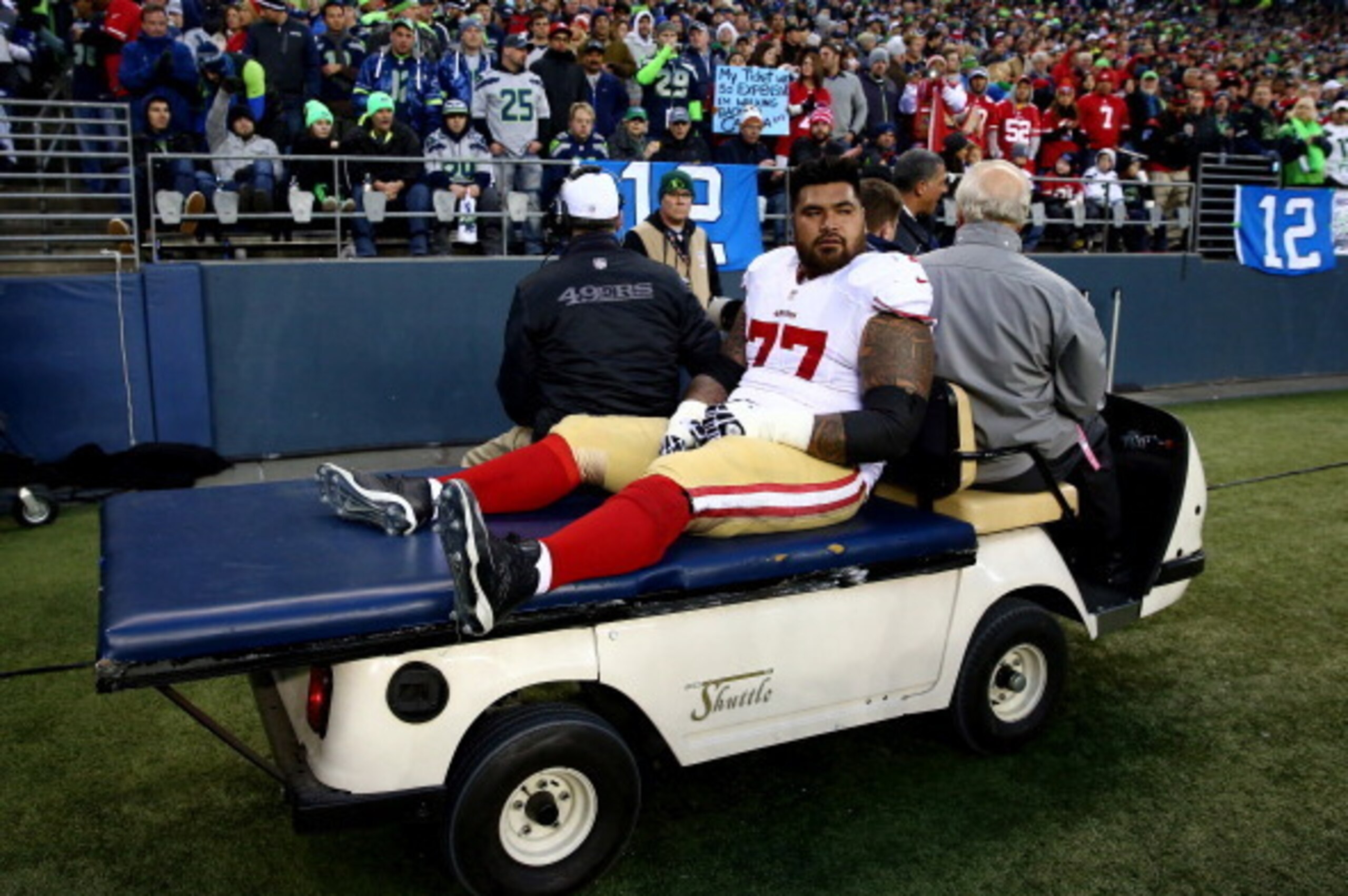 SEATTLE, WA - JANUARY 19:  Guard Mike Iupati #77 of the San Francisco 49ers is carted off the field against the Seattle Seahawks during the 2014 NFC Championship at CenturyLink Field on January 19, 2014 in Seattle, Washington.  (Photo by Tom Pennington/Ge