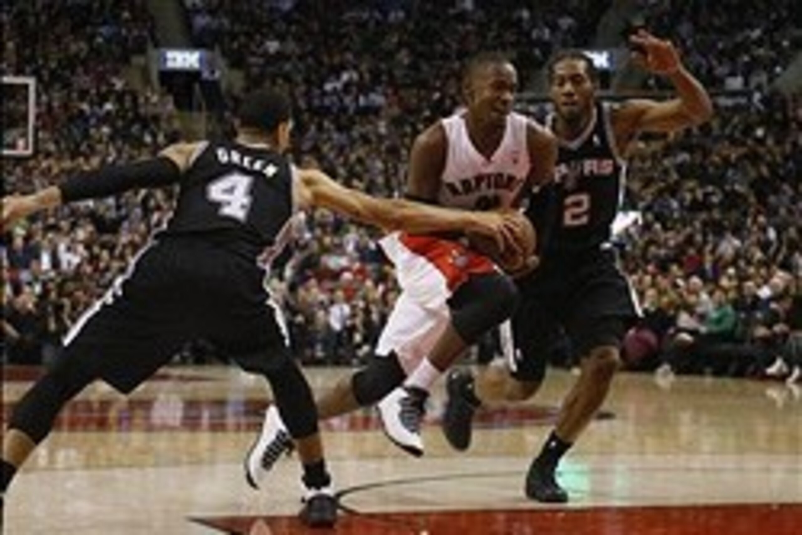 Dec 10, 2013; Toronto, Ontario, CAN; San Antonio Spurs guard-forward Danny Green (4) fouls against Toronto Raptors guard Terrence Ross (31) as he gets by San Antonio Spurs forward Kawhi Leonard (2) at the Air Canada Centre. San Antonio defeated Toronto 11