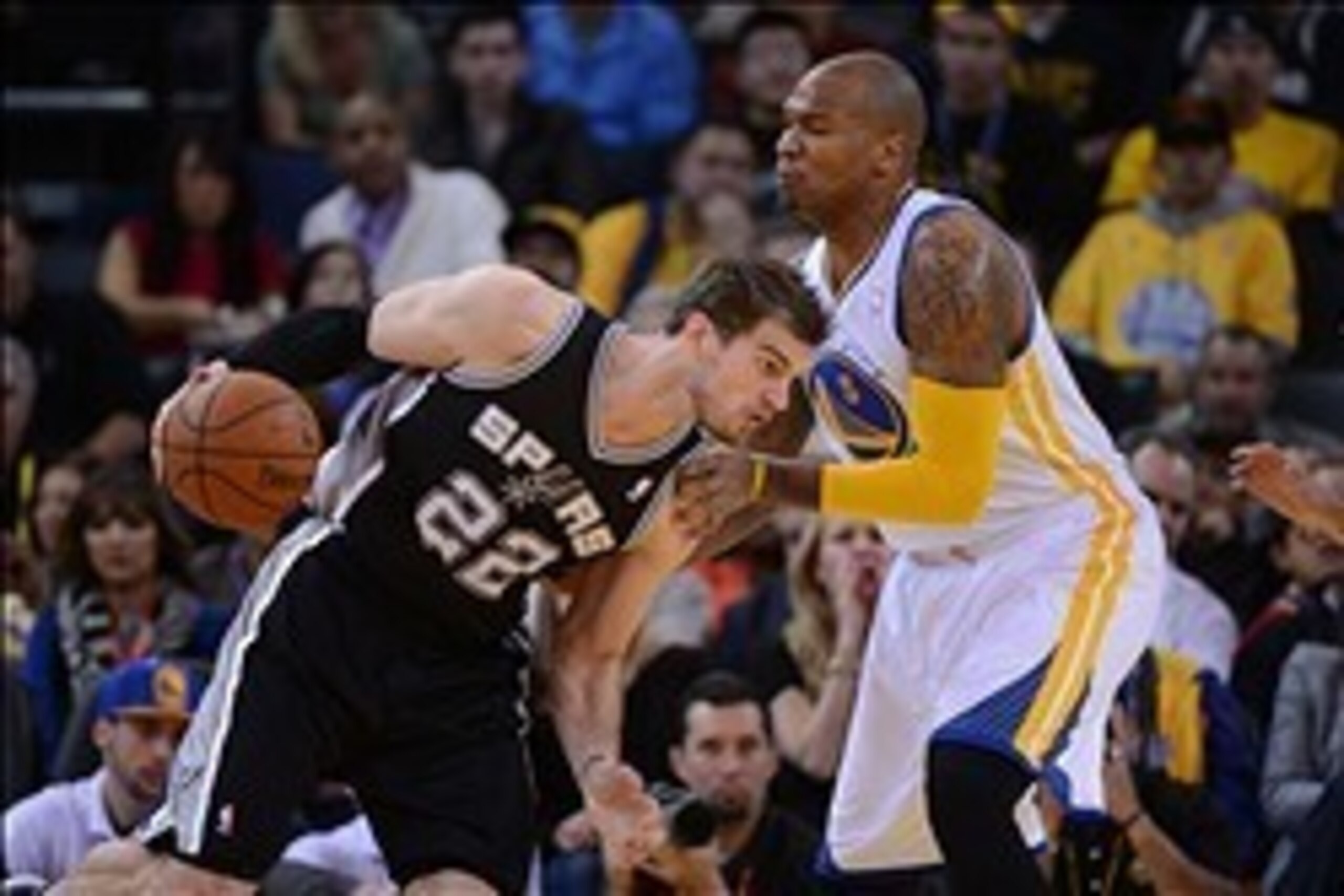 December 19, 2013; Oakland, CA, USA; San Antonio Spurs center Tiago Splitter (22) dribbles against Golden State Warriors power forward Marreese Speights (5) during the first quarter at Oracle Arena. Mandatory Credit: Kyle Terada-USA TODAY Sports
