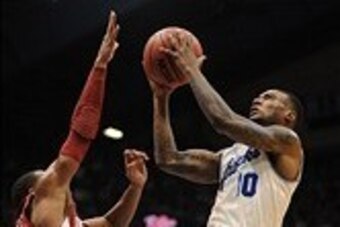 Feb 24, 2014; Lawrence, KS, USA; Kansas Jayhawks guard Naadir Tharpe (10) shoots the ball as Oklahoma Sooners guard Jordan Woodard (10) defends during the second half at Allen Fieldhouse. Kansas won 83-75. Mandatory Credit: Denny Medley-USA TODAY Sports