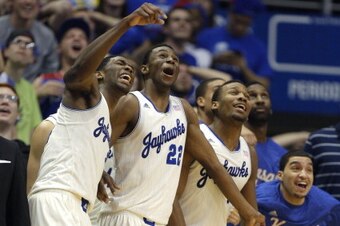 LAWRENCE, KS - FEBRUARY 22:  Joel Embiid #21, Andrew Wiggins #22 and members of the Kansas Jayhawks react to a dunk by Tarik Black of the Kansas Jayhawks during a game against the Texas Longhorns in the second half at Allen Fieldhouse on February 22, 2014