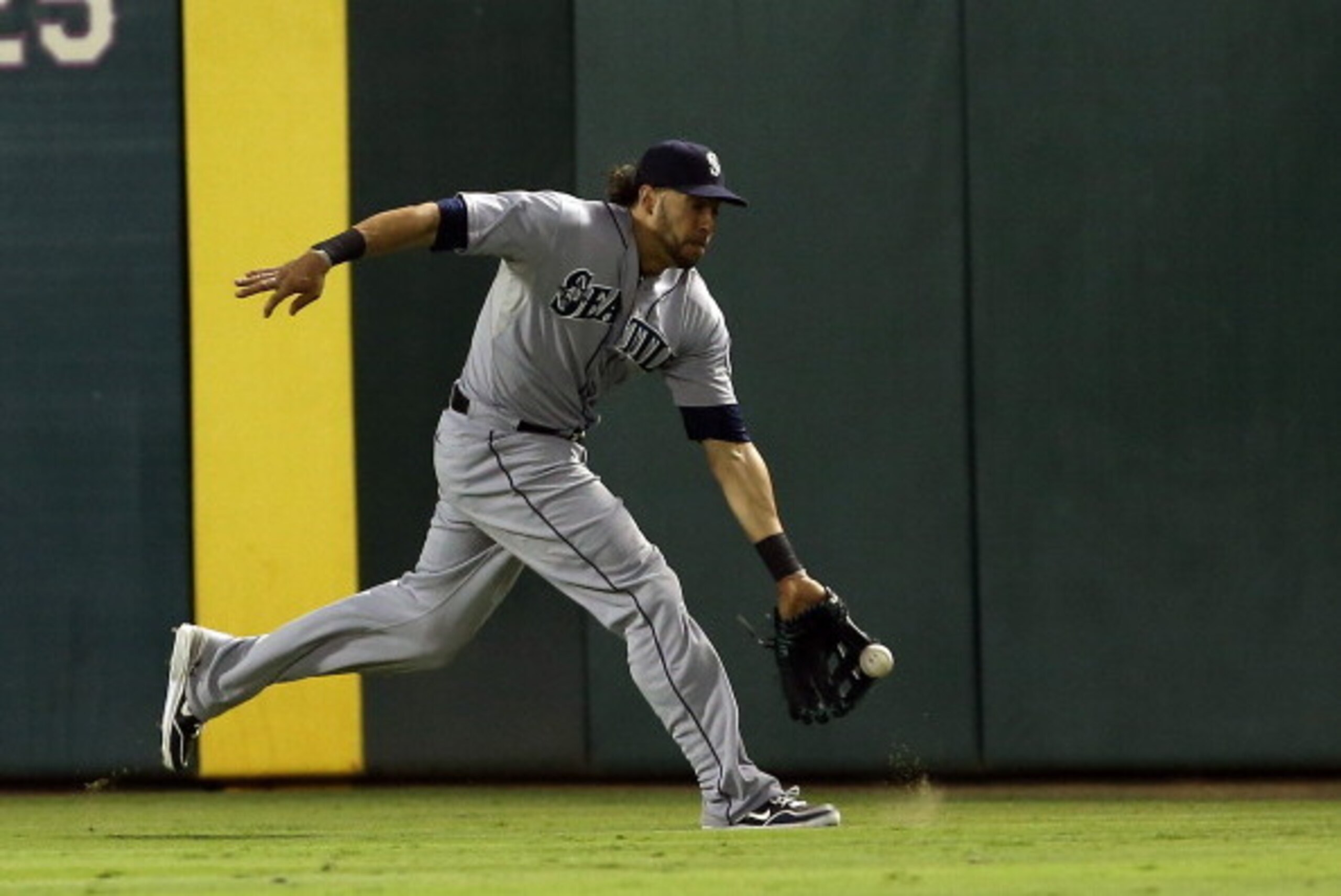 ARLINGTON, TX - AUGUST 17: Michael Morse #38 of the Seattle Mariners fields a fly ball off the bat of Ian Kinsler #5 of the Texas Rangers in the eighth inning at Rangers Ballpark in Arlington on August 17, 2013 in Arlington, Texas.  (Photo by Rick Yeatts/