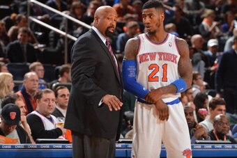 NEW YORK, NY - JANUARY 7: Mike Woodson of the New York Knicks shares a word with Iman Shumpert #21 during the game against the Detroit Pistons on January 7, 2014 at Madison Square Garden in New York City, New York. NOTE TO USER: User expressly acknowledge