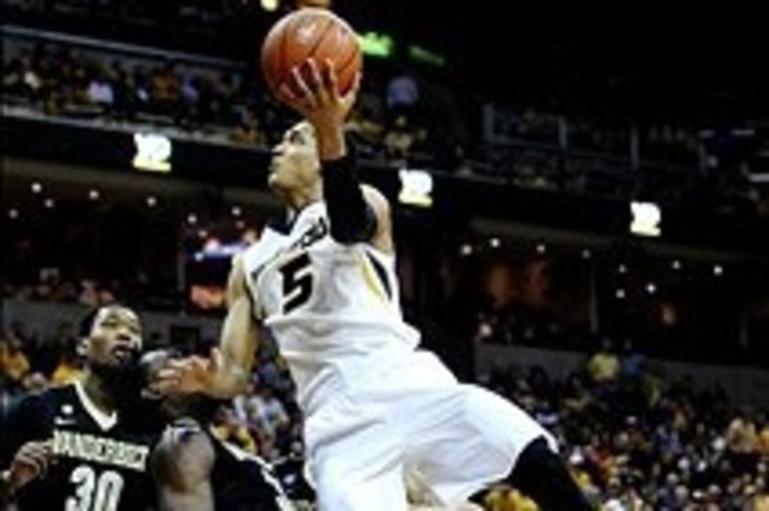 Feb 19, 2014; Columbia, MO, USA; Missouri Tigers guard Jordan Clarkson (5) goes for a basket over Vanderbilt Commodores forward James Siakam (35) and Vanderbilt Commodores forward/center Damian Jones (30) during the second half at Mizzou Arena. The Missou