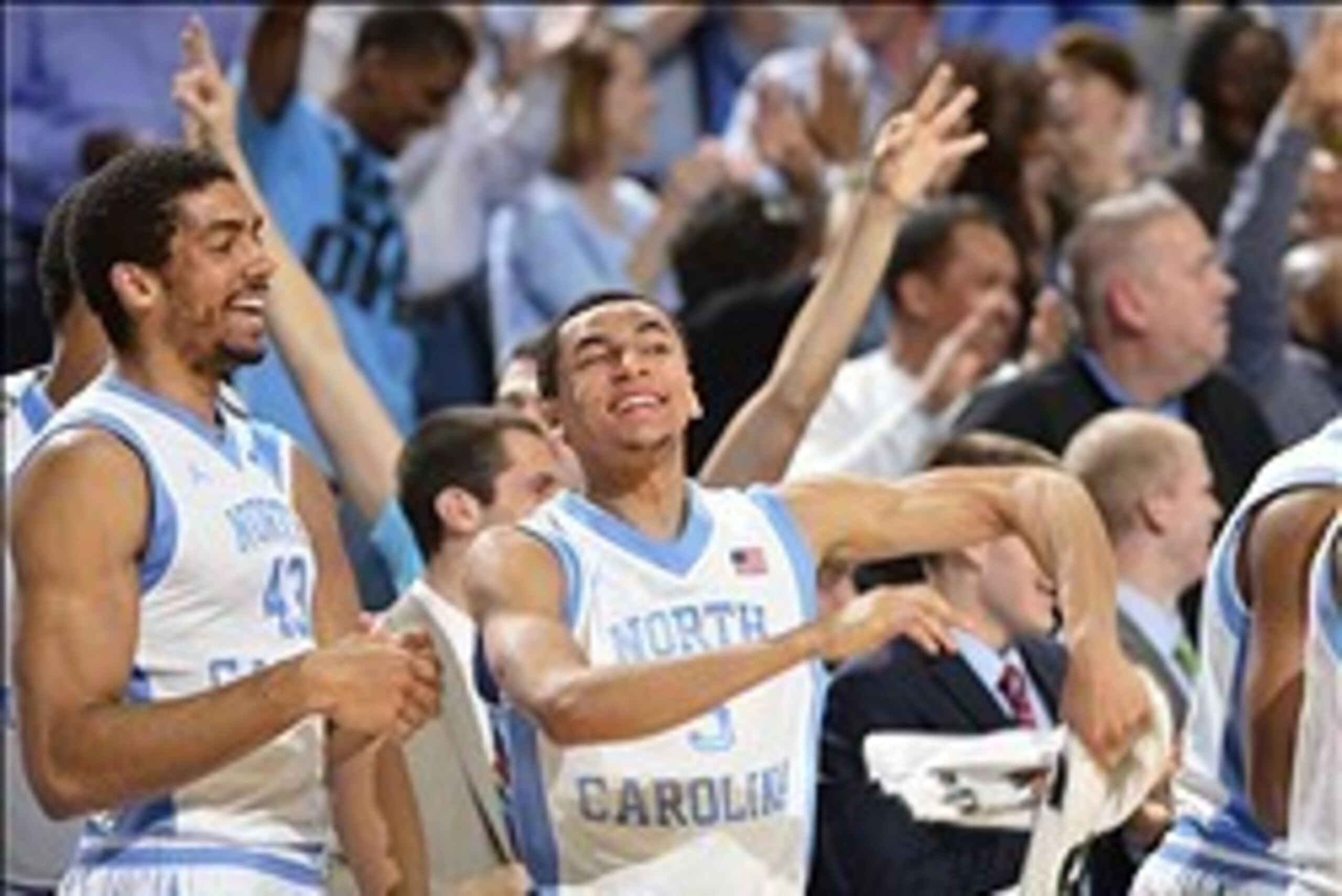 Feb 22, 2014; Chapel Hill, NC, USA; North Carolina Tar Heels forward James Michael McAdoo (43) and guard Marcus Paige (5) react on the bench late in the second half. The Tar Heels defeated the Demon Deacons 105-72 at Dean E. Smith Student Activities Cente
