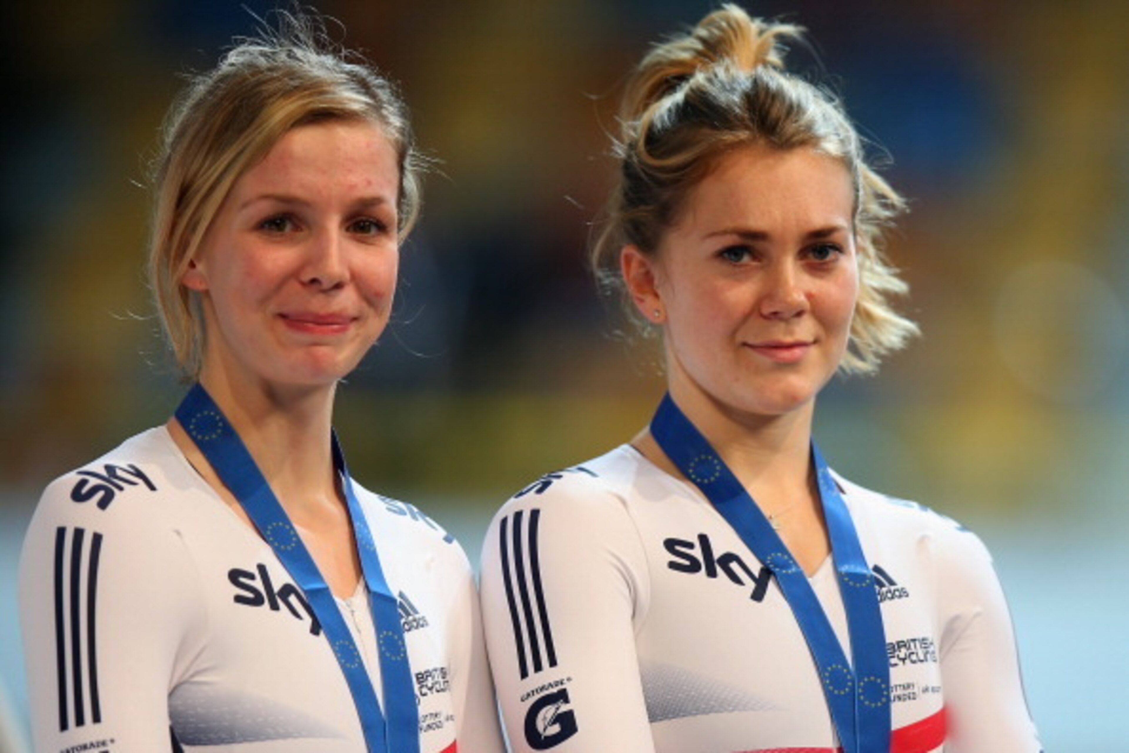 APELDOORN, NETHERLANDS - OCTOBER 18:  Rebecca James (l) of Great Britain chats to team mate Jessica Varnish on the podium after finishing 3rd in the Women's Team Sprint Final during day one of the 2013 European Elite Track Championship at Omnisport Apeldo
