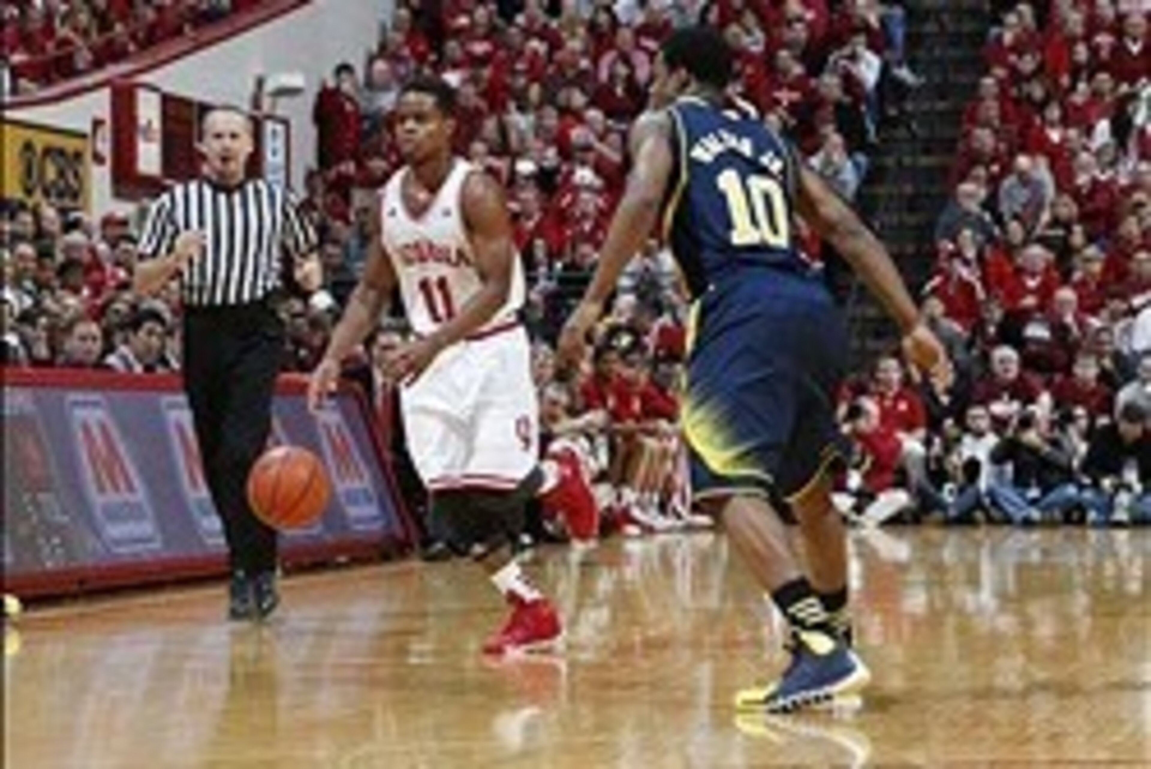 Feb 2, 2014; Bloomington, IN, USA; Indiana Hoosiers guard Yogi Ferrell (11) drives to the basket against Michigan Wolverines guard Derrick Walton Jr. (10) at Assembly Hall. Mandatory Credit: Brian Spurlock-USA TODAY Sports Feb 2, 2014; Bloomington, IN, USA; Indiana Hoosiers guard Yogi Ferrell (11) drives to the basket against Michigan Wolverines guard Derrick Walton Jr. (10) at Assembly Hall. Mandatory Credit: Brian Spurlock-USA TODAY Sports