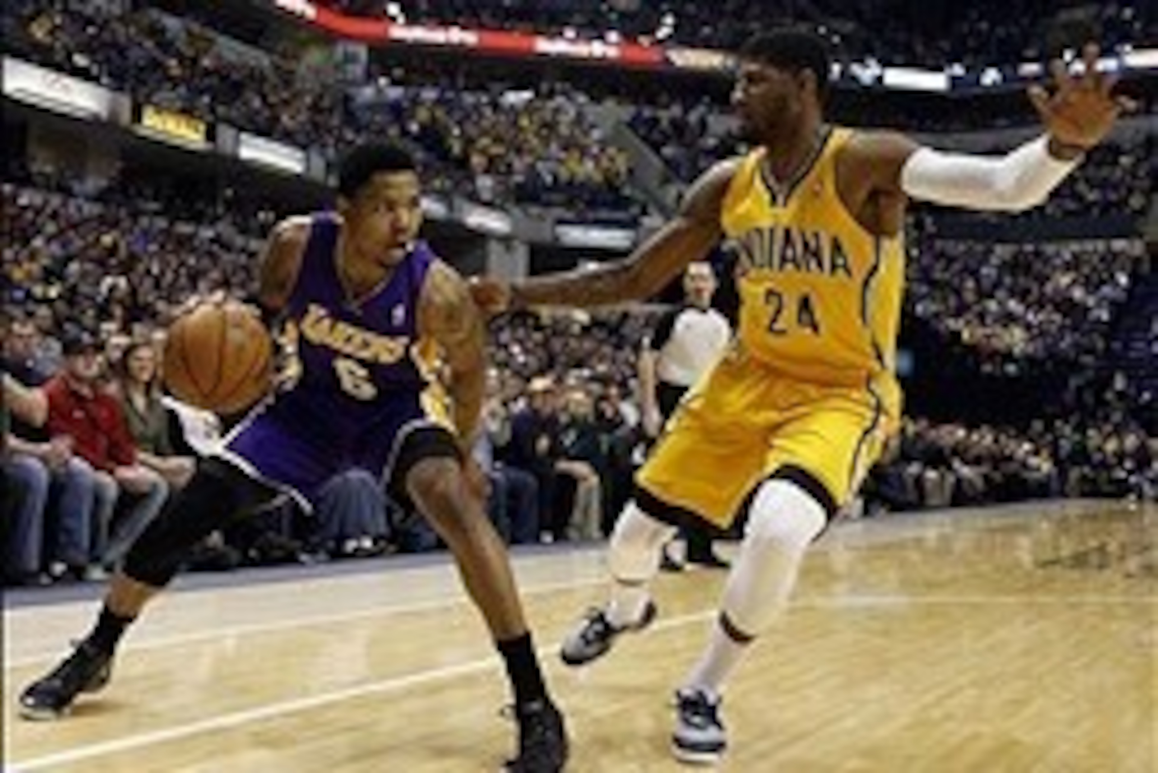 Feb 25, 2014; Indianapolis, IN, USA; Los Angeles Lakers guard Kent Bazemore (6) drives to the basket against Indiana Pacers forward Paul George (24) at Bankers Life Fieldhouse. Mandatory Credit: Brian Spurlock-USA TODAY Sports