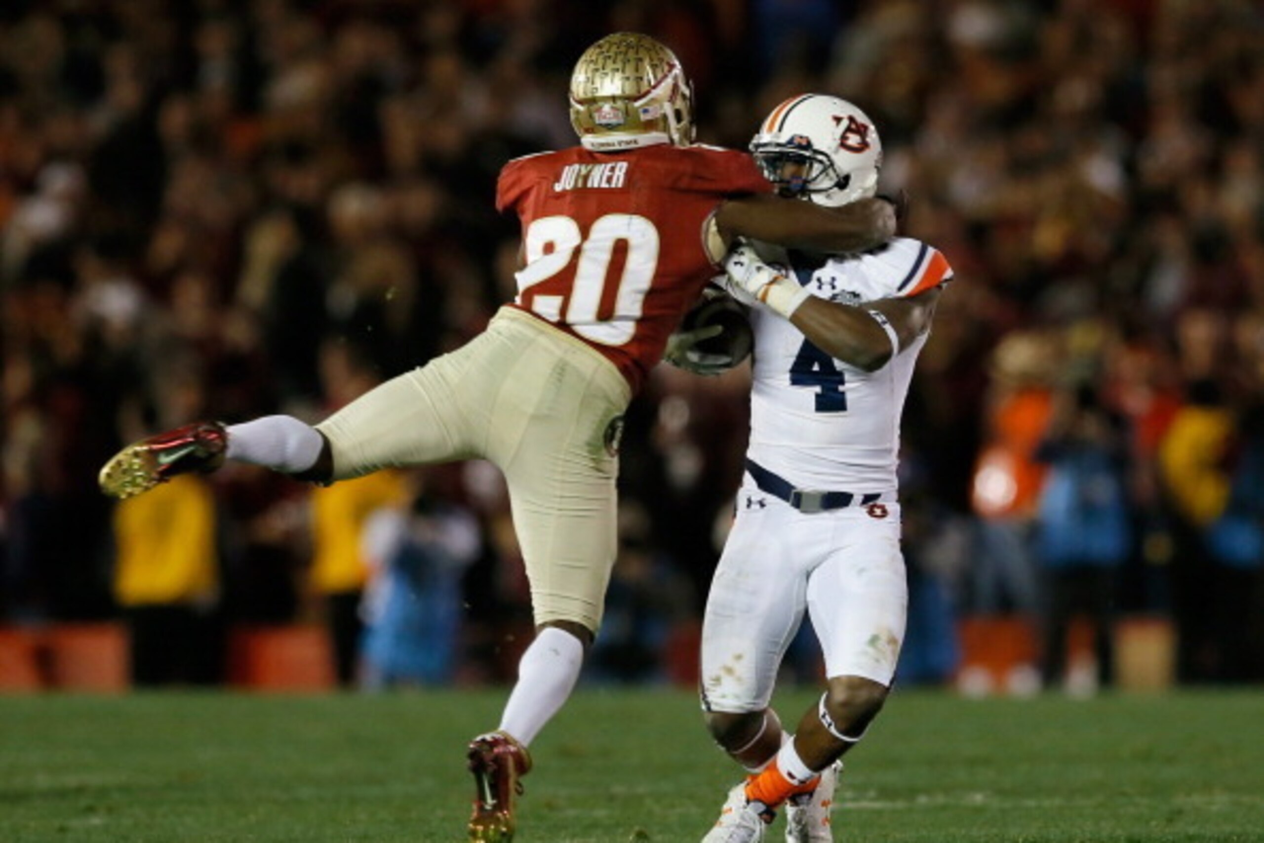 PASADENA, CA - JANUARY 06:  Defensive back Lamarcus Joyner #20 of the Florida State Seminoles hits wide receiver Quan Bray #4 of the Auburn Tigers during the 2014 Vizio BCS National Championship Game at the Rose Bowl on January 6, 2014 in Pasadena, Califo