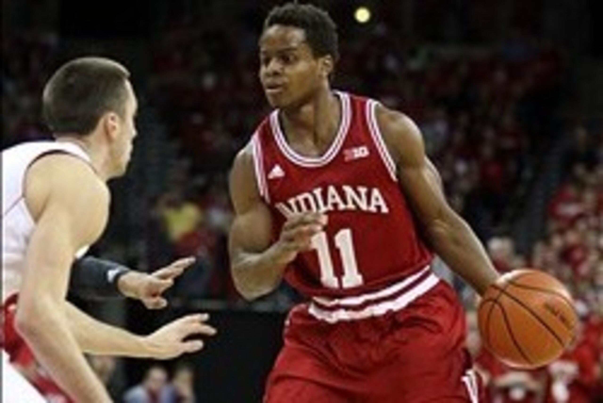 Feb 25, 2014; Madison, WI, USA; Indiana Hoosiers guard Yogi Ferrell (11) attempts to move the ball around Wisconsin Badgers guard Josh Gasser (right) during the first half at the Kohl Center. Mandatory Credit: Mary Langenfeld-USA TODAY Sports Feb 25, 2014; Madison, WI, USA; Indiana Hoosiers guard Yogi Ferrell (11) attempts to move the ball around Wisconsin Badgers guard Josh Gasser (right) during the first half at the Kohl Center. Mandatory Credit: Mary Langenfeld-USA TODAY Sports