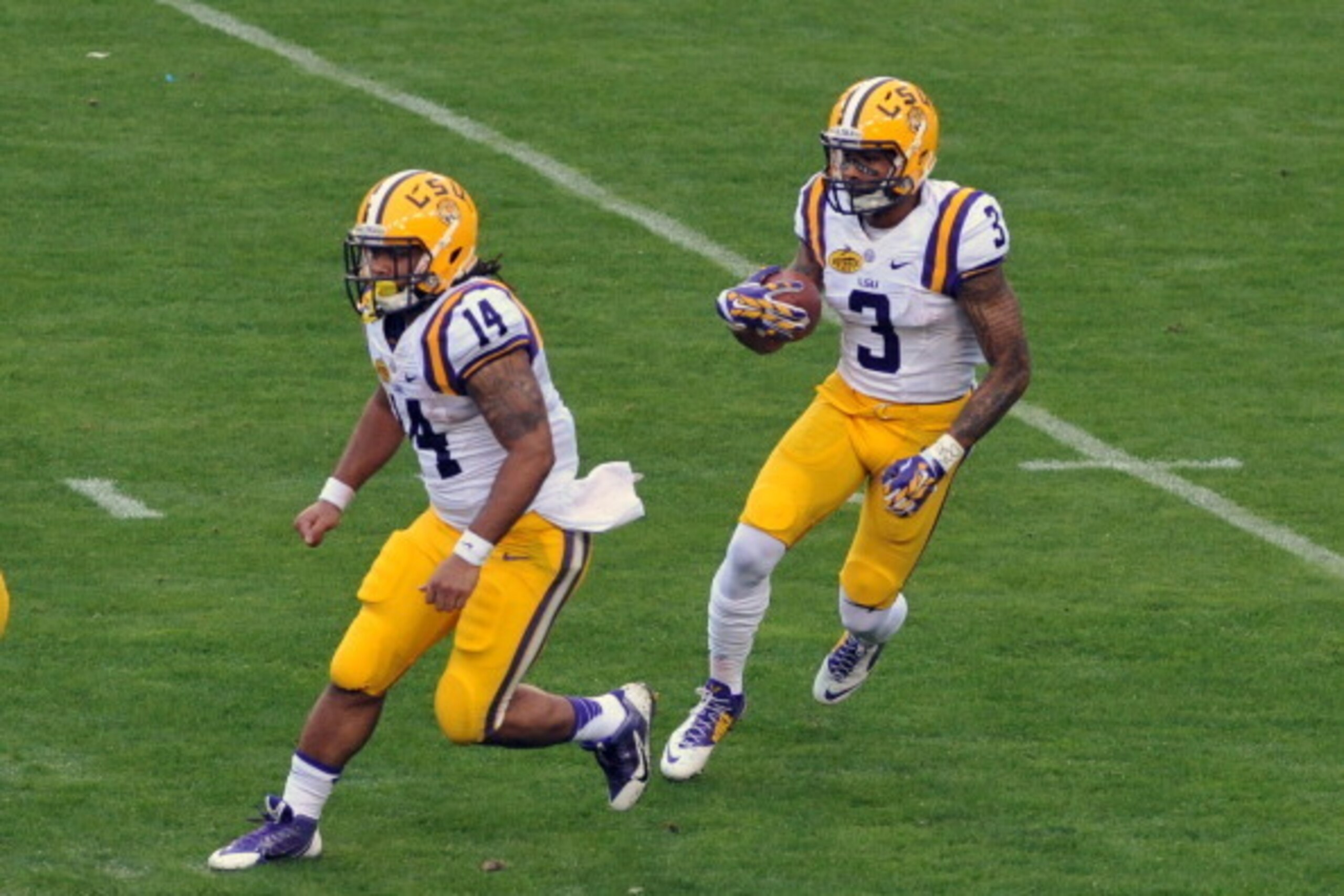TAMPA, FL -  JANUARY 1:  Wide receiver O'Dell Beckham Jr. #3 of the LSU Tigers returns a kick with  Lionel Williams #14 leading the way against the Iowa Hawkeyes January 1, 2014  in the Outback Bowl at Raymond James Stadium in Tampa, Florida.  LSU won 21 