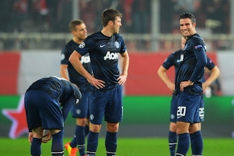 PIRAEUS, GREECE - FEBRUARY 25:  (L-R) Wayne Rooney, Michael Carrick and Robin van Persie  of Manchester United react as they restart the game after conceding the first goal during the UEFA Champions League Round of 16 first leg match between Olympiacos FC
