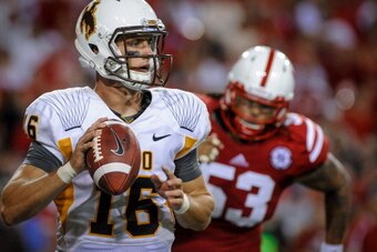 LINCOLN, NE - AUGUST 31: Quarterback Brett Smith #16 of the Wyoming Cowboys runs down field against the Nebraska Cornhuskers during their game at Memorial Stadium on August 31, 2013 in Lincoln, Nebraska. Nebraska defeated Wyoming 37-34. (Photo by Eric Fra