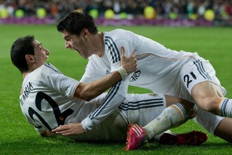 MADRID, SPAIN - FEBRUARY 05:  Angel Di Maria (L) of Real Madrid CF celebrates scoring their third goal with teammate Alvaro B. Morata during the Copa del Rey semifinal first leg match between Real Madrid CF and Club Atletico Madrid at Estadio Santiago Ber