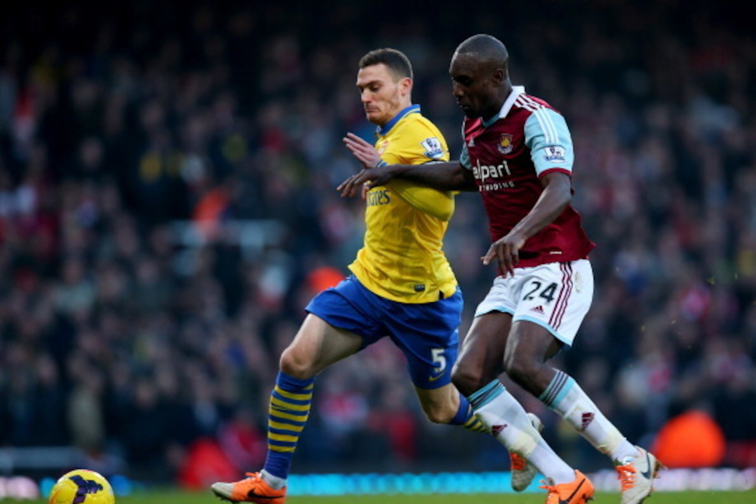 LONDON, ENGLAND - DECEMBER 26:  Thomas Vermaelen of Arsenal battles with Carlton Cole of West Ham United during the Barclays Premier League match between West Ham United and Arsenal at Boleyn Ground on December 26, 2013 in London, England.  (Photo by Bryn