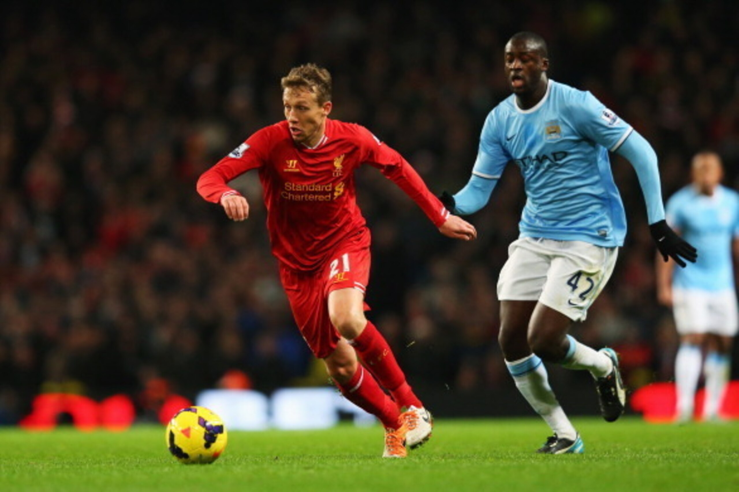MANCHESTER, ENGLAND - DECEMBER 26: Lucas of Liverpool is closed down by Yaya Toure of Manchester City during the Barclays Premier League match between Manchester City and Liverpool at Etihad Stadium on December 26, 2013 in Manchester, England.  (Photo by 