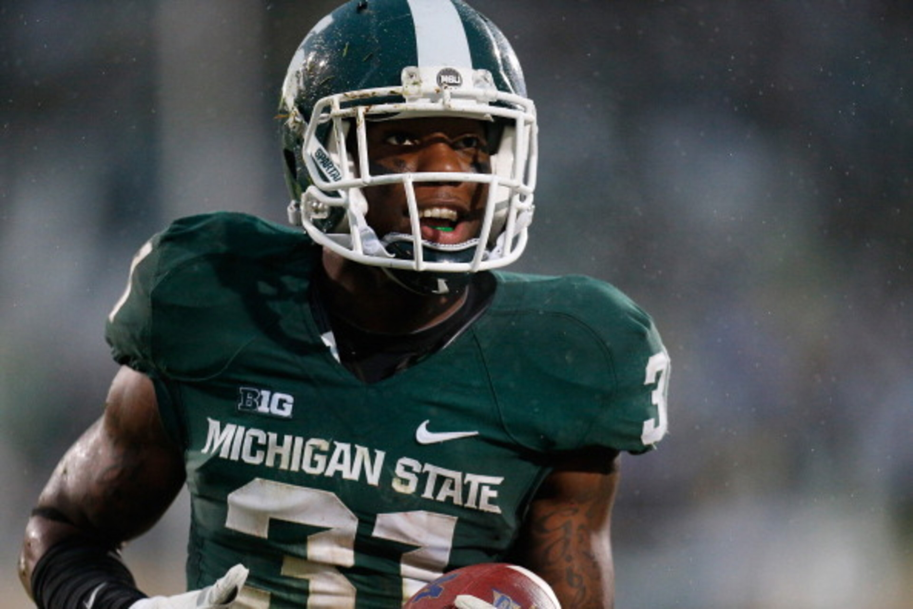 EAST LANSING, MI - NOVEMBER 02:  Darqueze Dennard #31 of the Michigan State Spartans celebrates his fourth-quarter interception against the Michigan Wolverines at Spartan Stadium on November 2, 2013 in East Lansing, Michigan. Michigan State won the game 2