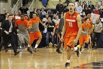 Feb 12, 2014; Pittsburgh, PA, USA; Syracuse Orange guard Tyler Ennis (11) and the Orange bench react after Ennis shoots a three point basket to defeat the Pittsburgh Panthers at the Petersen Events Center. Syracuse won 58-56. Mandatory Credit: Charles LeC