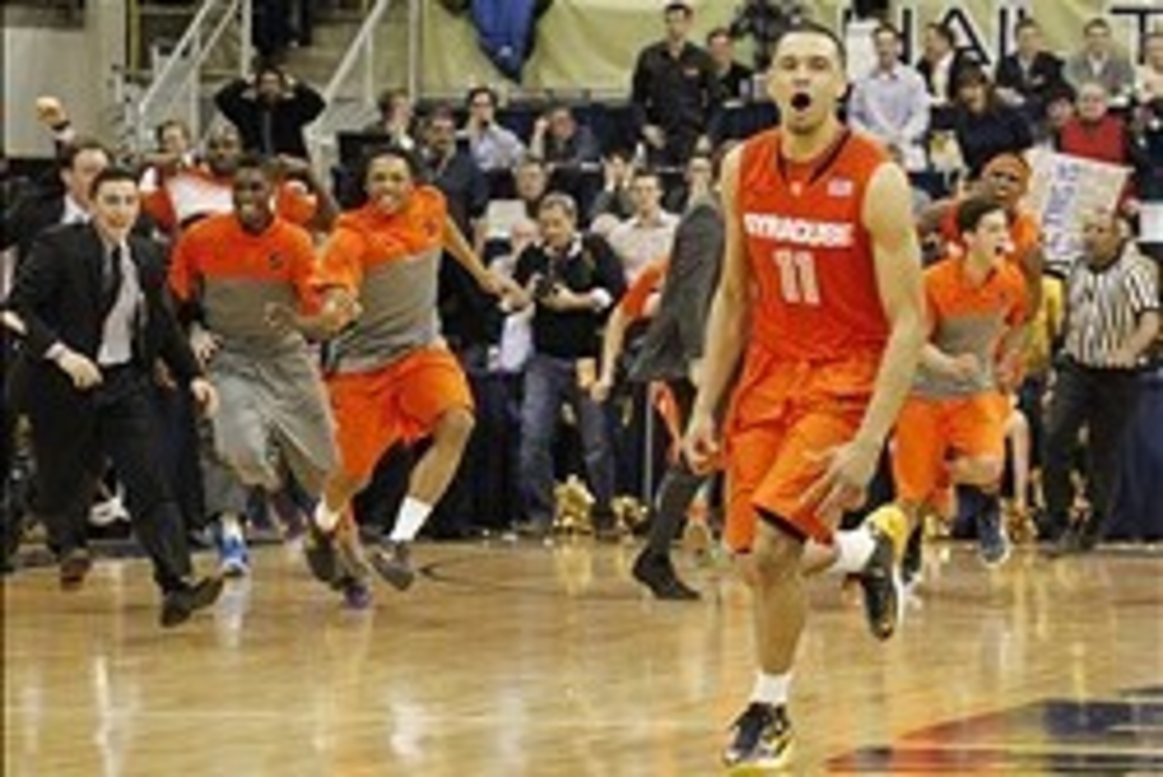 Feb 12, 2014; Pittsburgh, PA, USA; Syracuse Orange guard Tyler Ennis (11) and the Orange bench react after Ennis shoots a three point basket to defeat the Pittsburgh Panthers at the Petersen Events Center. Syracuse won 58-56. Mandatory Credit: Charles LeC