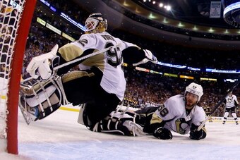 BOSTON, MA - JUNE 05: Kris Letang #58 collides with Tomas Vokoun #92 of the Pittsburgh Penguins  during overtime in  Game Three of the Eastern Conference Final of the 2013 NHL Stanley Cup Playoffs against the Boston Bruins at the TD Garden on June 5, 2013