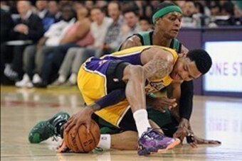 Feb 21, 2014; Los Angeles, CA, USA; Los Angeles Lakers guard Kent Bazemore (6) battles for the ball with Boston Celtics guard Rajon Rondo (9) during the second quarter at Staples Center. The Lakers won 101-92. Mandatory Credit: Kelvin Kuo-USA TODAY Sports