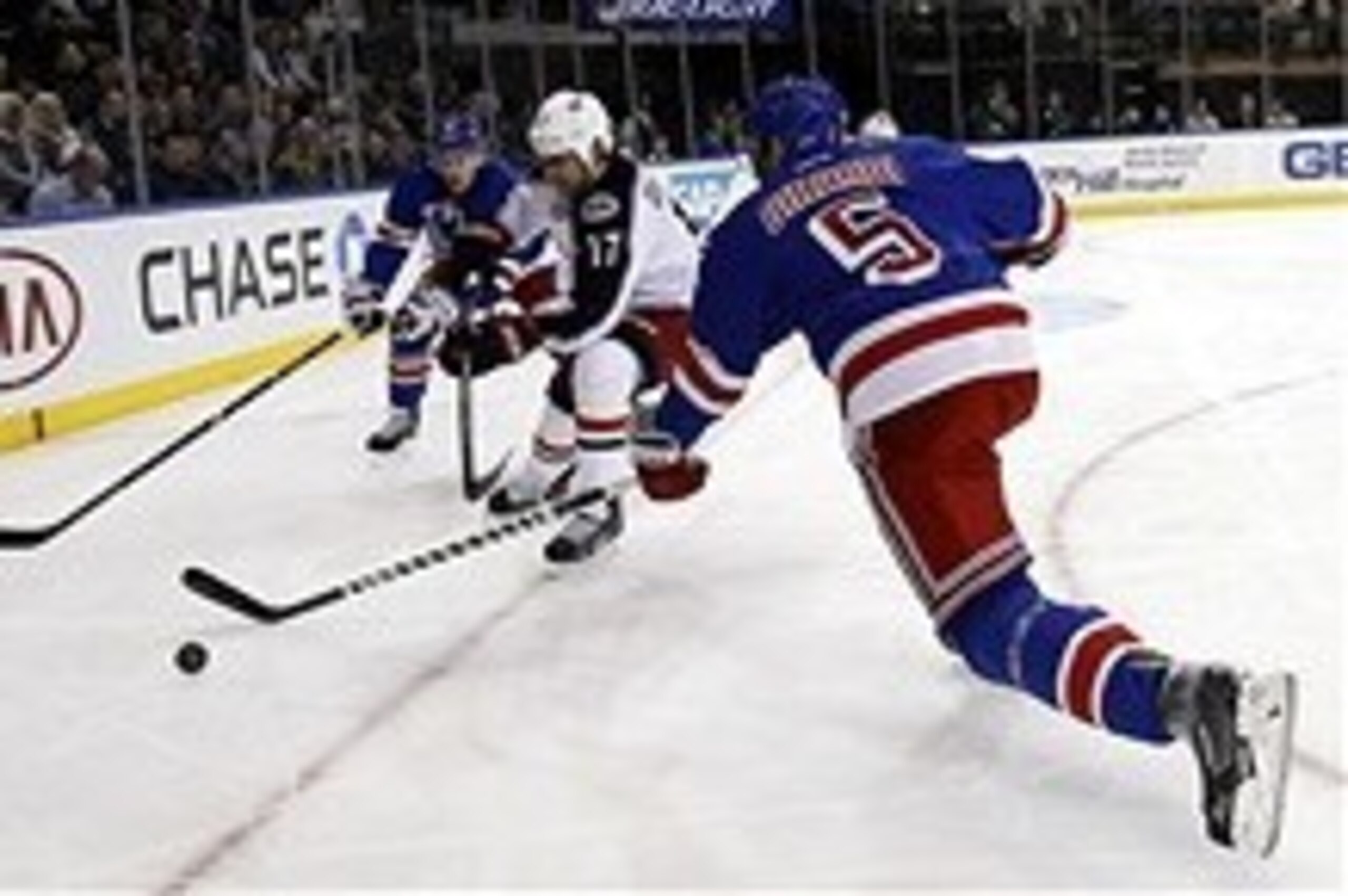 Jan 6, 2014; New York, NY, USA; Columbus Blue Jackets center Brandon Dubinsky (17) fights for the puck with New York Rangers defenseman Dan Girardi (5) during the first period at Madison Square Garden. Mandatory Credit: Adam Hunger-USA TODAY Sports