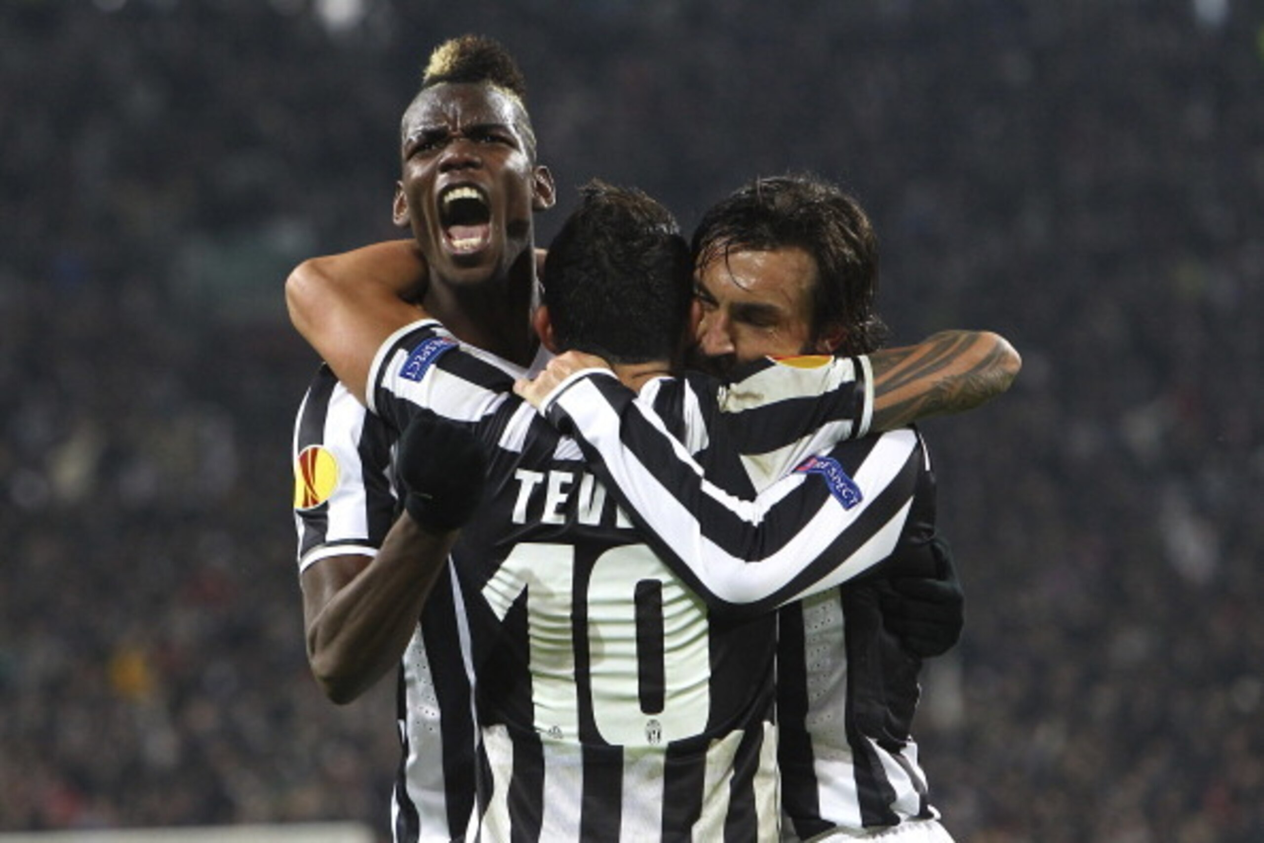 TURIN, ITALY - FEBRUARY 20:  Paul Pogba (L) of Juventus FC celebrates with his team-mates Carlos Tevez (C) and Andrea Pirlo (R) during the UEFA Europa League Round of 32 match between Juventus and AS Trabzonspor at Juventus Arena on February 20, 2014 in T