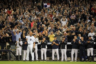 Sep 26, 2013; Bronx, NY, USA; New York Yankees relief pitcher Mariano Rivera (42) tips his cap as his teammate and the fans cheer after he was taken out in the ninth inning against the Tampa Bay Rays at Yankee Stadium. Mandatory Credit: John Munson/THE ST