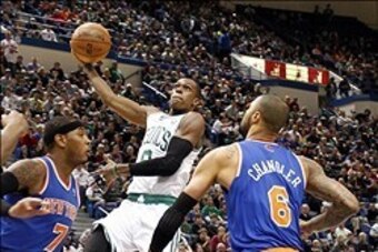 Oct 13, 2012; Hartford, CT, USA; Boston Celtics guard Rajon Rondo (9) shoots the ball against New York Knicks forward Carmelo Anthony (7) and center Tyson Chandler (6) during the first half at XL Center.  Mandatory Credit: Mark L. Baer-USA TODAY Sports