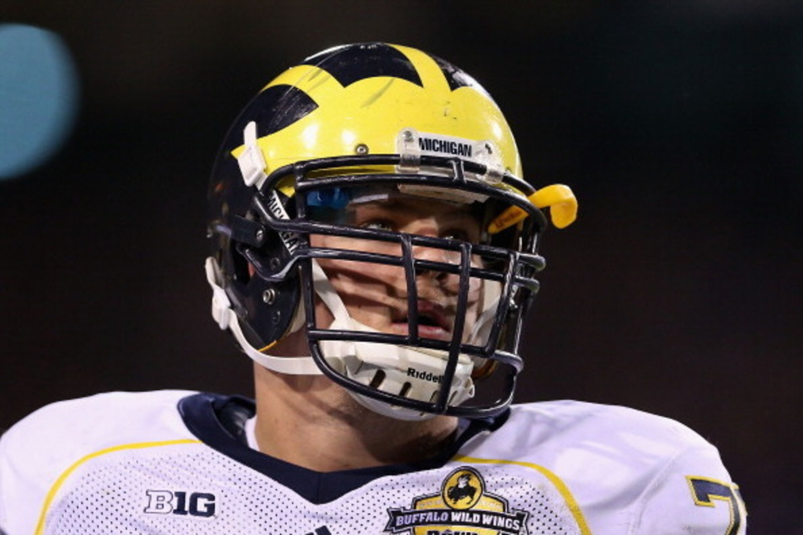 TEMPE, AZ - DECEMBER 28:  Offensive linesman Taylor Lewan #77 of the Michigan Wolverines stands on the sidelines during the Buffalo Wild Wings Bowl against the Kansas State Wildcats at Sun Devil Stadium on December 28, 2013 in Tempe, Arizona. The Wildcats
