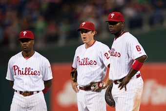 Sep 26, 2012; Philadelphia, PA, USA; Philadelphia Phillies shortstop Jimmy Rollins (11) second baseman Chase Utley (26) and first baseman Ryan Howard (6) stand by and watch during a pitching change during the ninth inning against the Washington Nationals