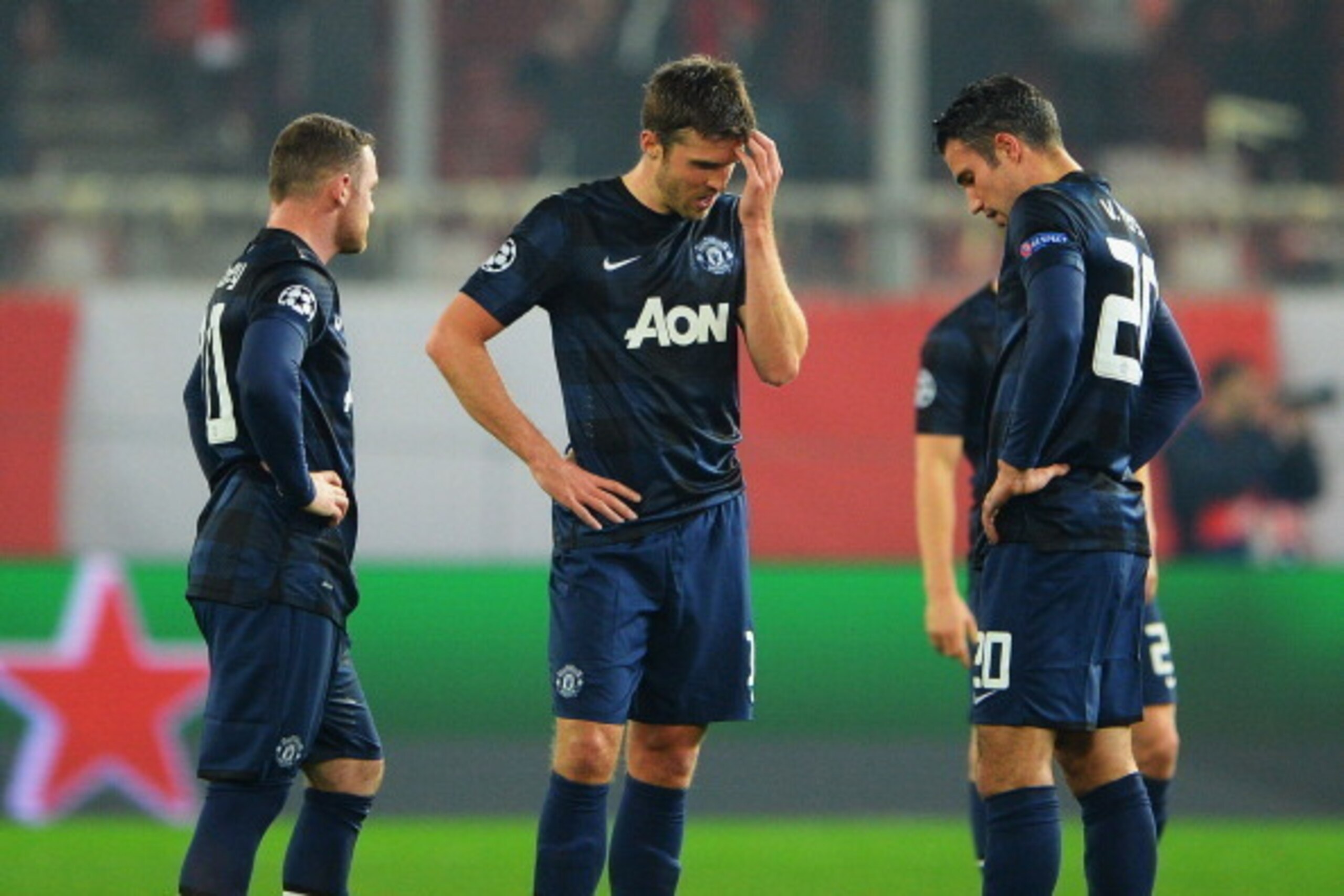 PIRAEUS, GREECE - FEBRUARY 25:  (L-R) Wayne Rooney, Michael Carrick and Robin van Persie  of Manchester United react as they restart the game after conceding the first goal during the UEFA Champions League Round of 16 first leg match between Olympiacos FC