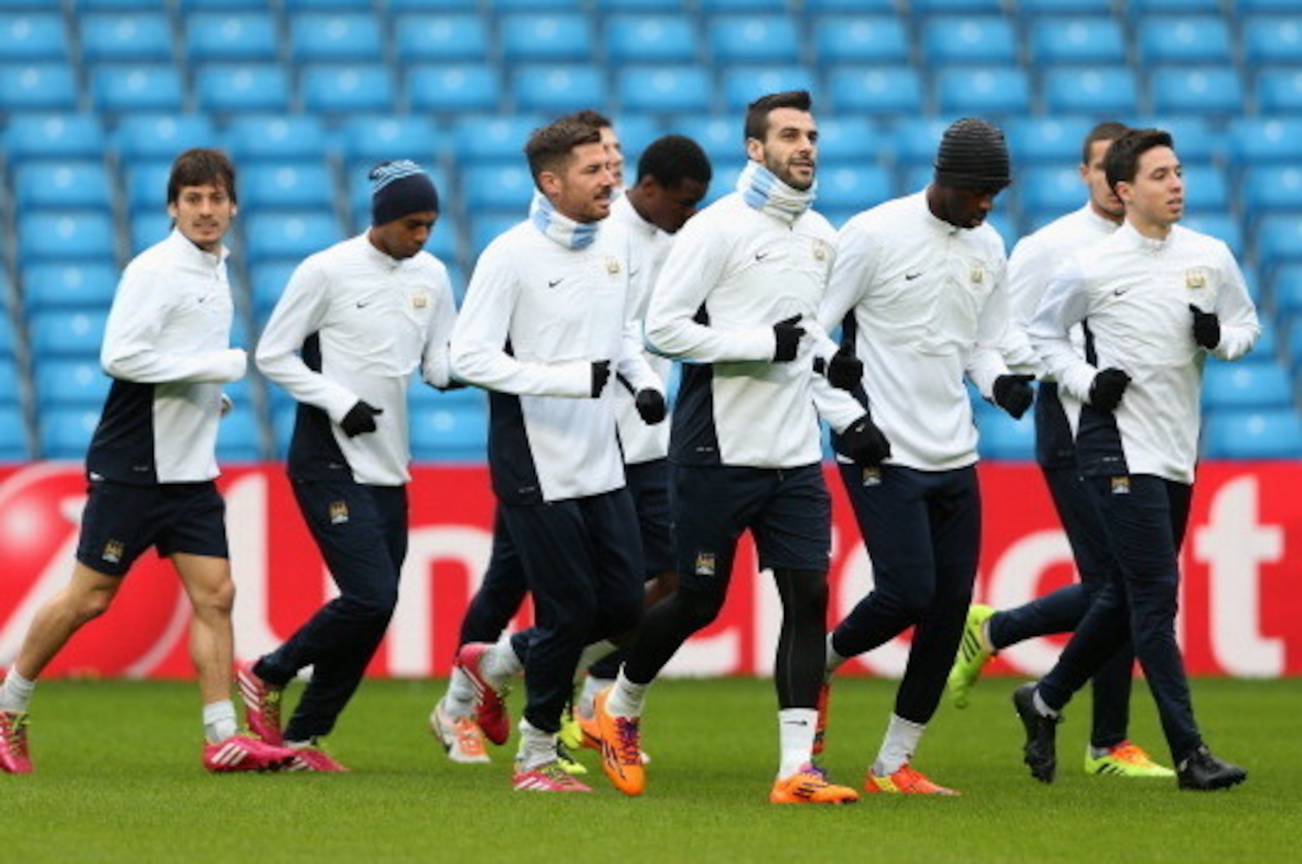 MANCHESTER, ENGLAND - FEBRUARY 17:  Samir Nasri of  Manchester City leads the pack during a training session ahead of their UEFA Champions League Round of 16 match 1st leg against Barcelona  at Etihad Stadium on February 17, 2014 in Manchester, England.  