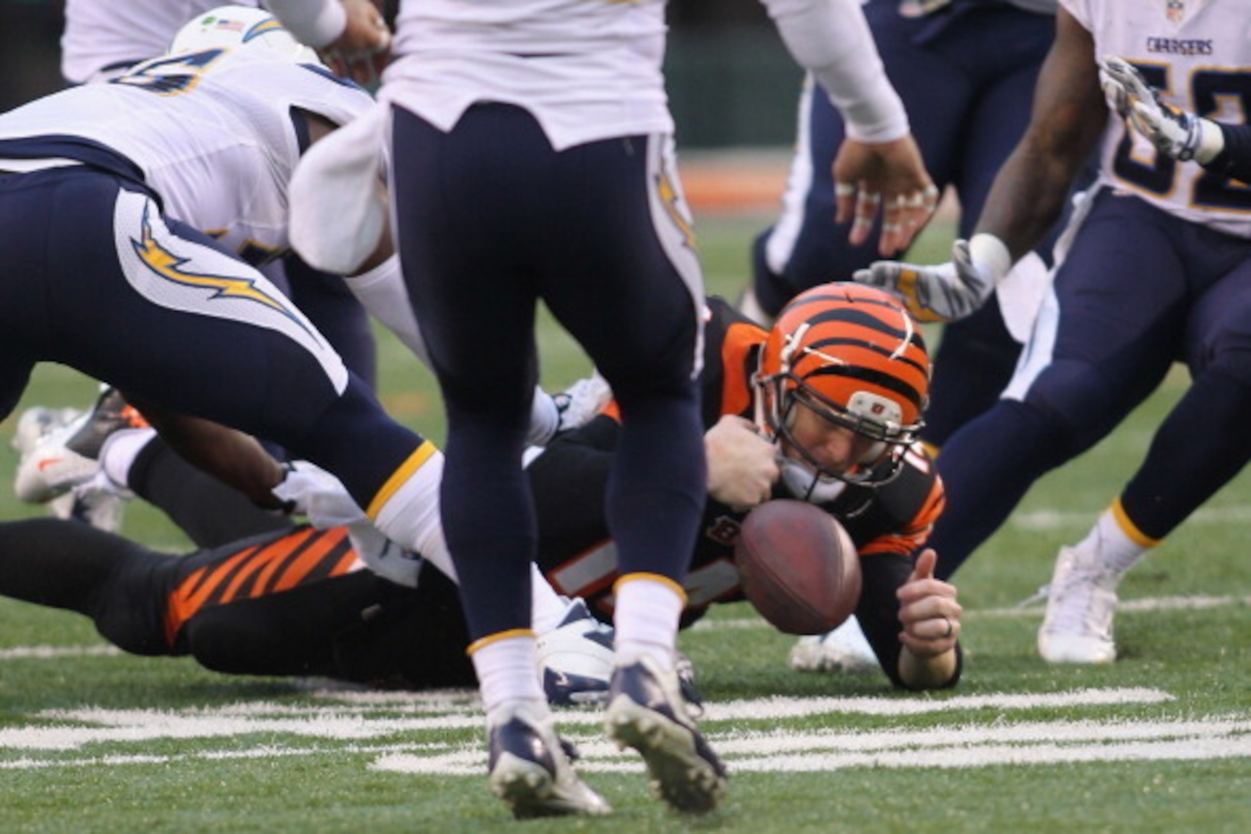 CINCINNATI, OH - JANUARY 05:  Andy Dalton #14 of the Cincinnati Bengals fumbles the football away in the second half of the AFC Wild Card playoff game against the San Diego Chargers at Paul Brown Stadium on January 5, 2014 in Cincinnati, Ohio.  The Charge