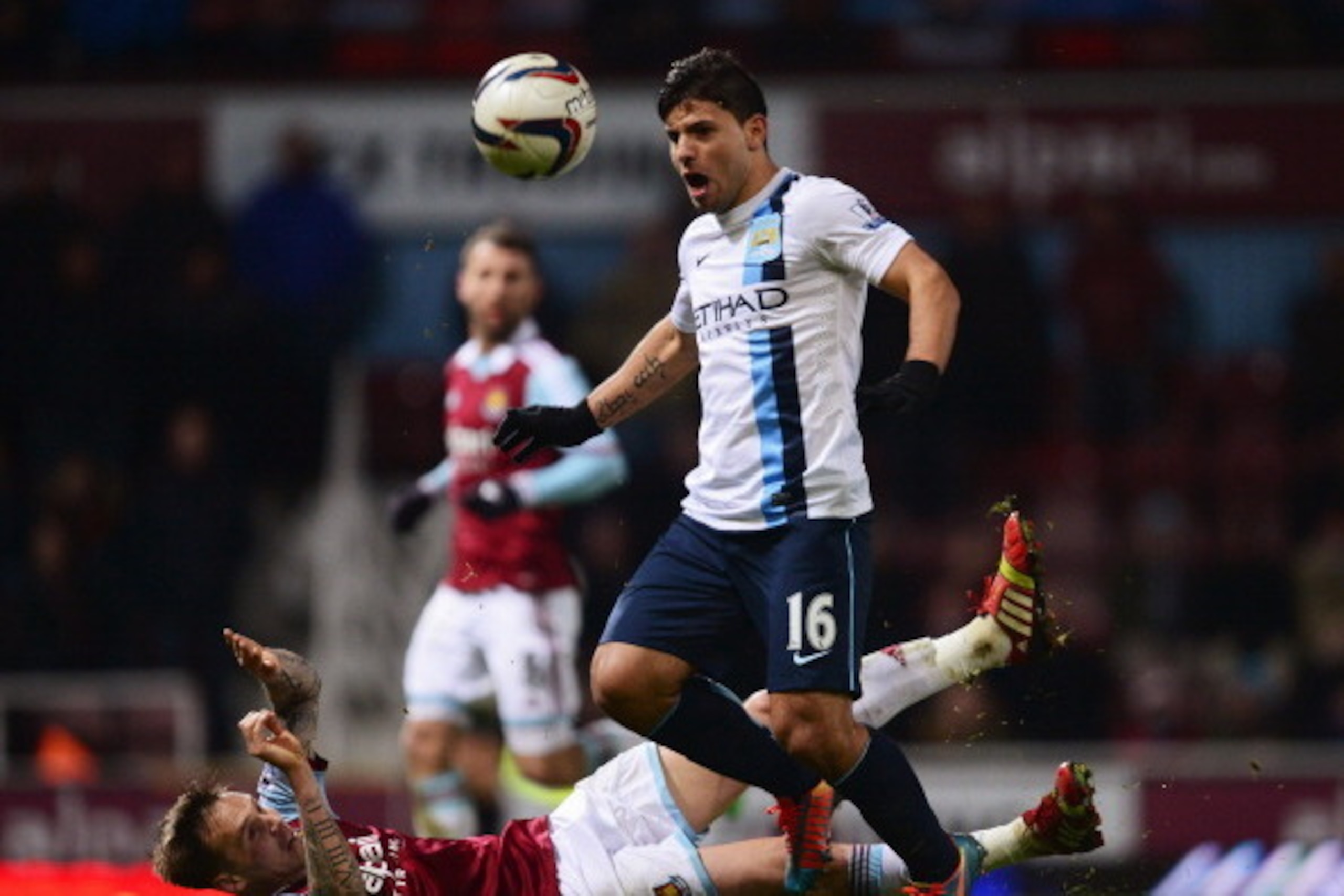 LONDON, ENGLAND - JANUARY 21:  Sergio Aguero of Manchester City evades Matthew Taylor of West Ham United during the Capital One Cup Semi-Final, Second Leg match between West Ham United and Manchester City at Boleyn Ground on January 21, 2014 in London, En