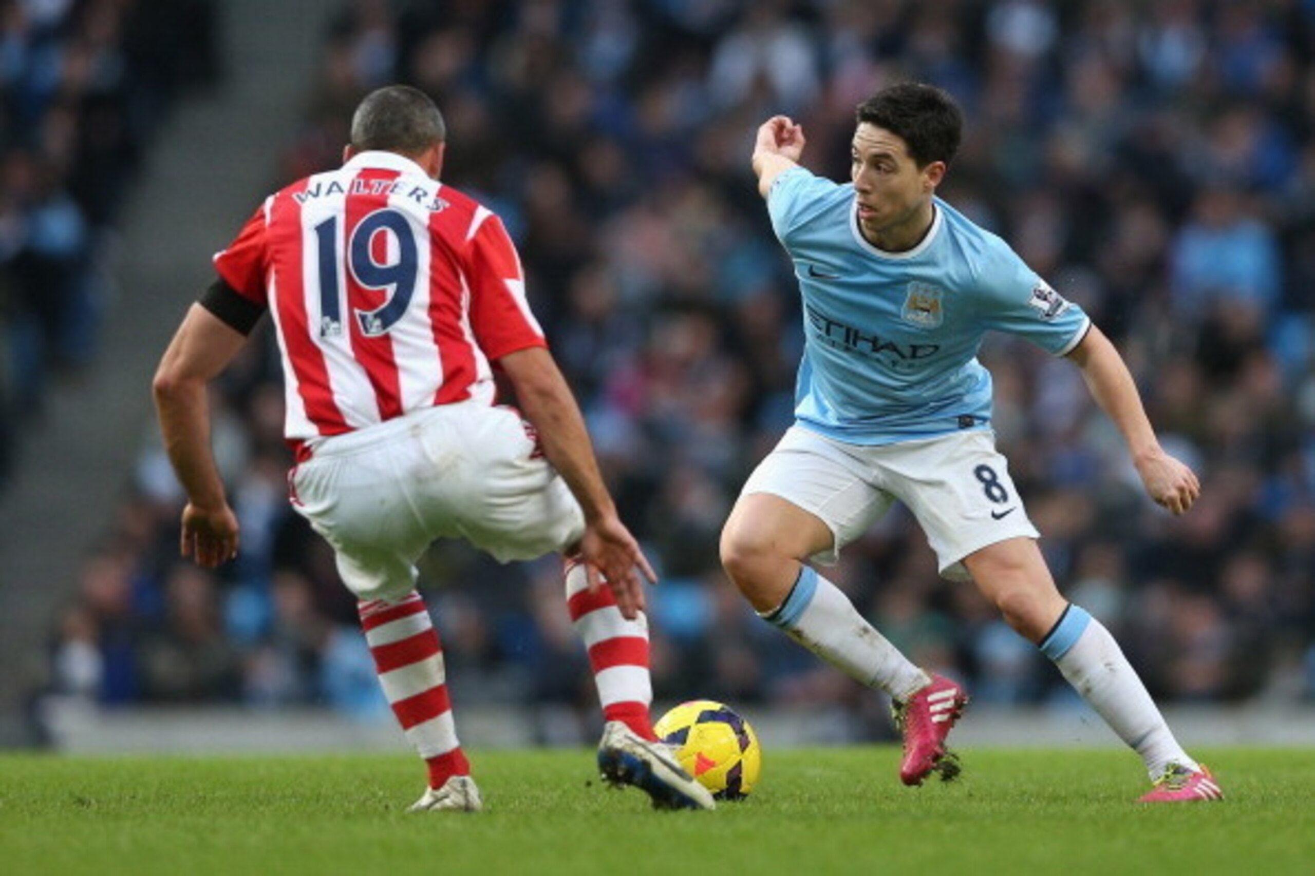 MANCHESTER, ENGLAND - FEBRUARY 22:  Samir Nasri of Manchester City attempts to move past Jonathan Walters of Stoke City during the Barclays Premier League match between Manchester City and Stoke City at the Etihad Stadium on February 22, 2014 in Mancheste