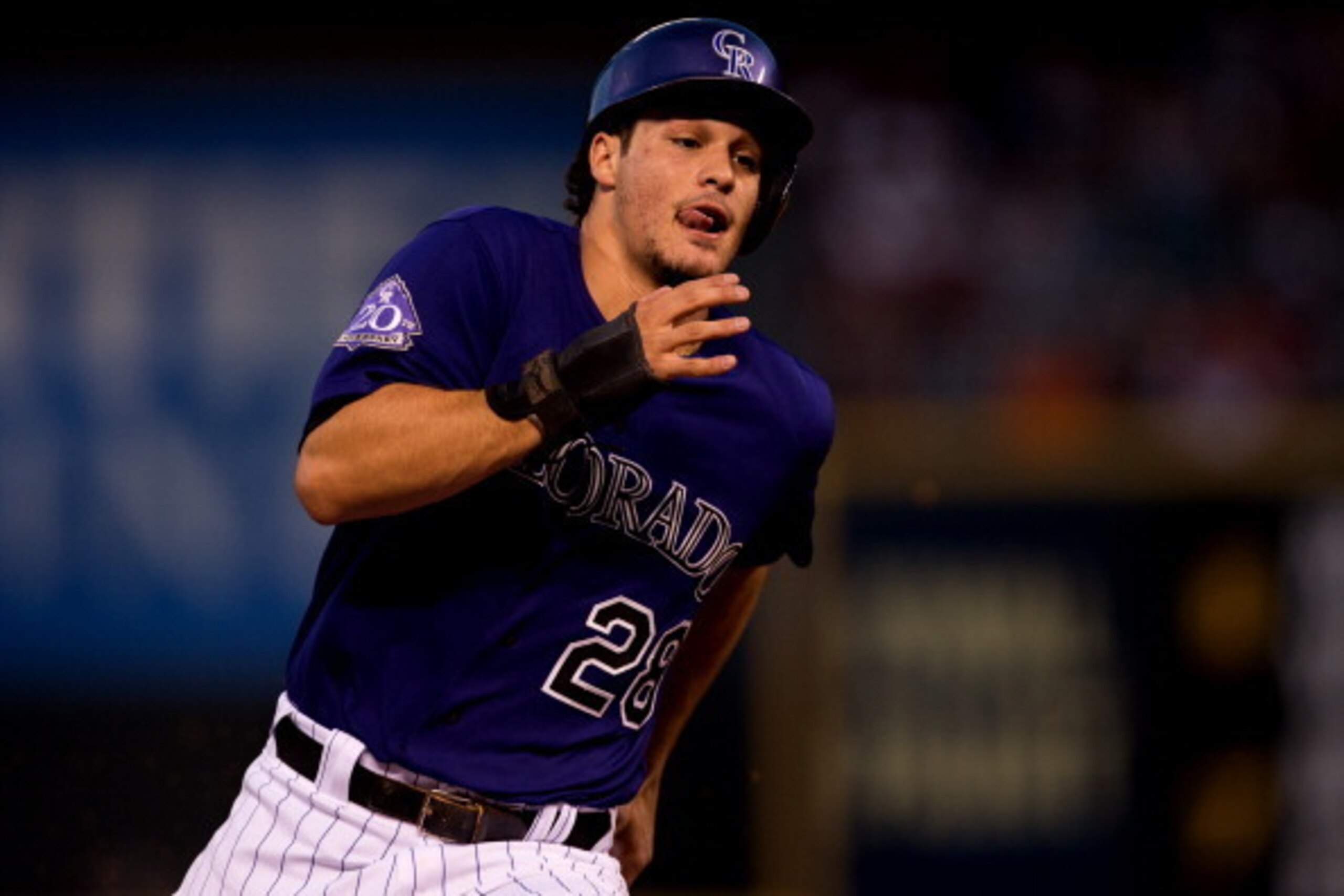 DENVER, CO - AUGUST 27:  Nolan Arenado #28 of the Colorado Rockies rounds third base on his way to scoring during the third inning against the San Francisco Giants at Coors Field on August 27, 2013 in Denver, Colorado.  The Giants defeated the Rockies 5-3