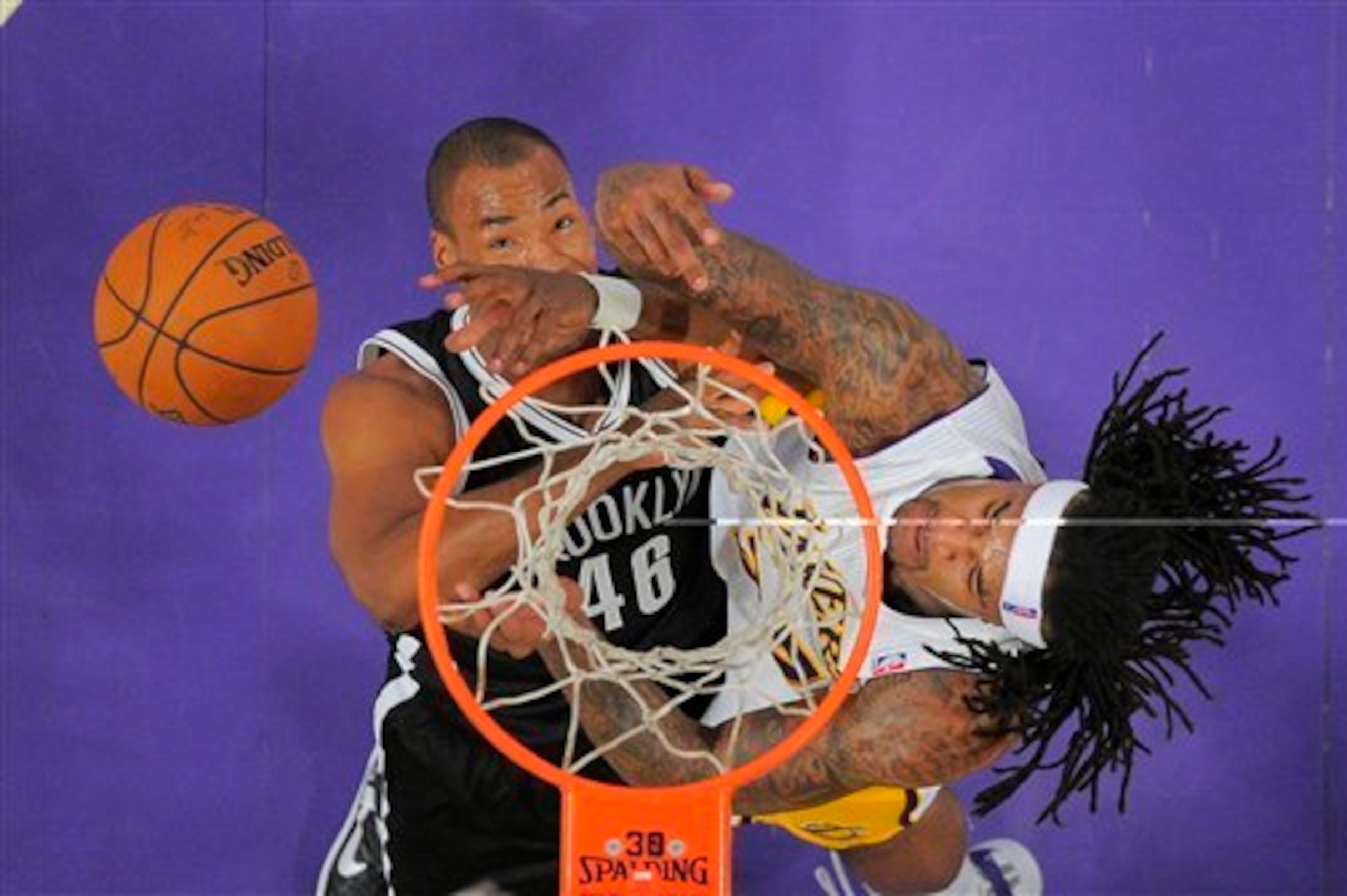 Jason Collins battles Jordan Hill for a rebound during the Nets' 108-102 win over the Los Angeles Lakers on Feb. 23.