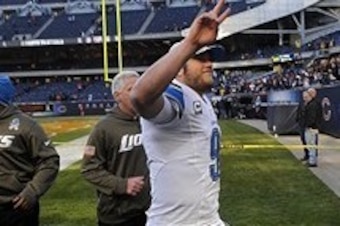 Nov 10, 2013; Chicago, IL, USA;  Detroit Lions quarterback Matthew Stafford (9) waves to fans after the Lions beat the Bears 21-19 at Soldier Field. Mandatory Credit: Matt Marton-USA TODAY Sports
